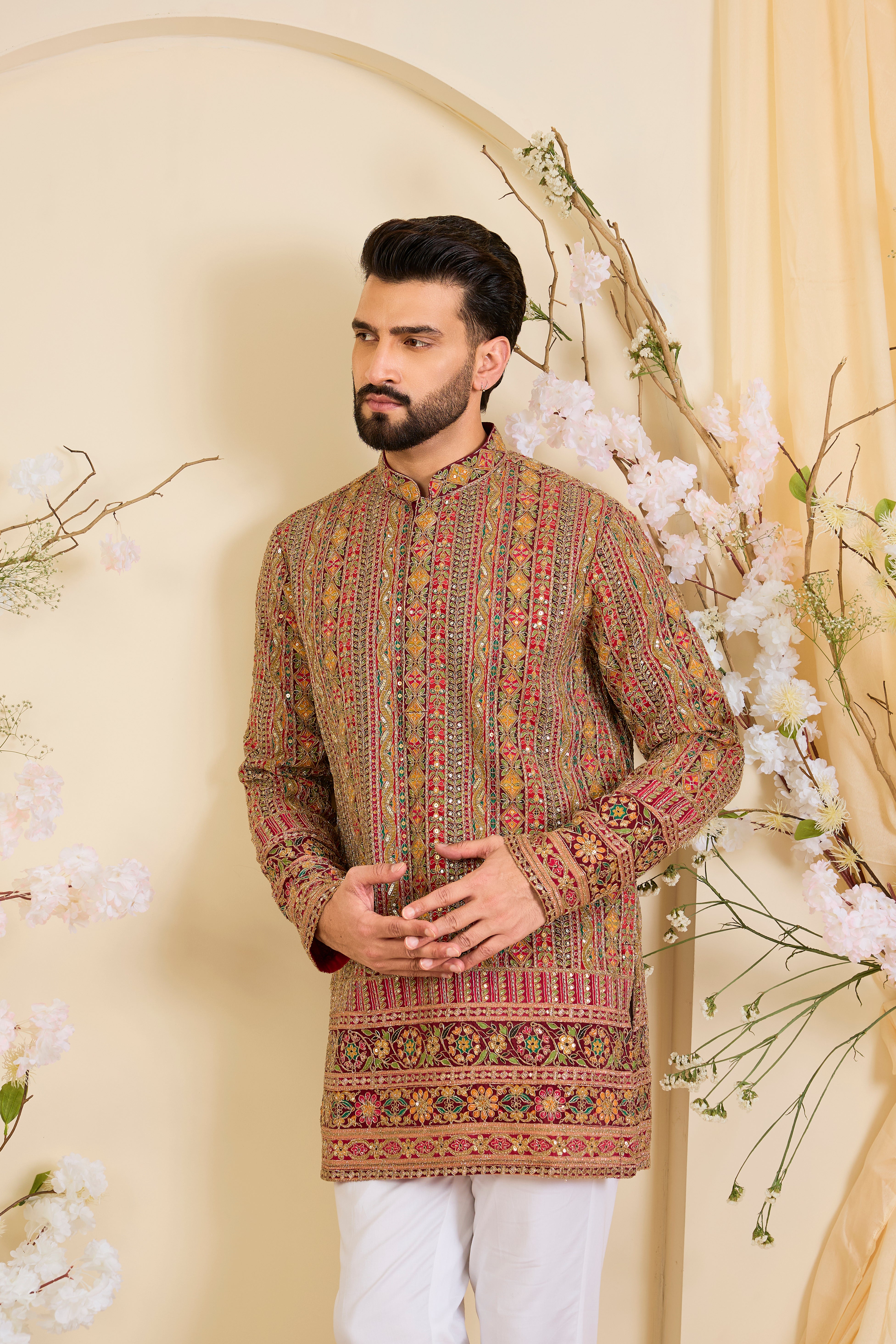 Pink base short kurta with heavy zari embroidery, intricate sequins, and multicolour prints, crafted for bold, opulent, statement-making occasions.