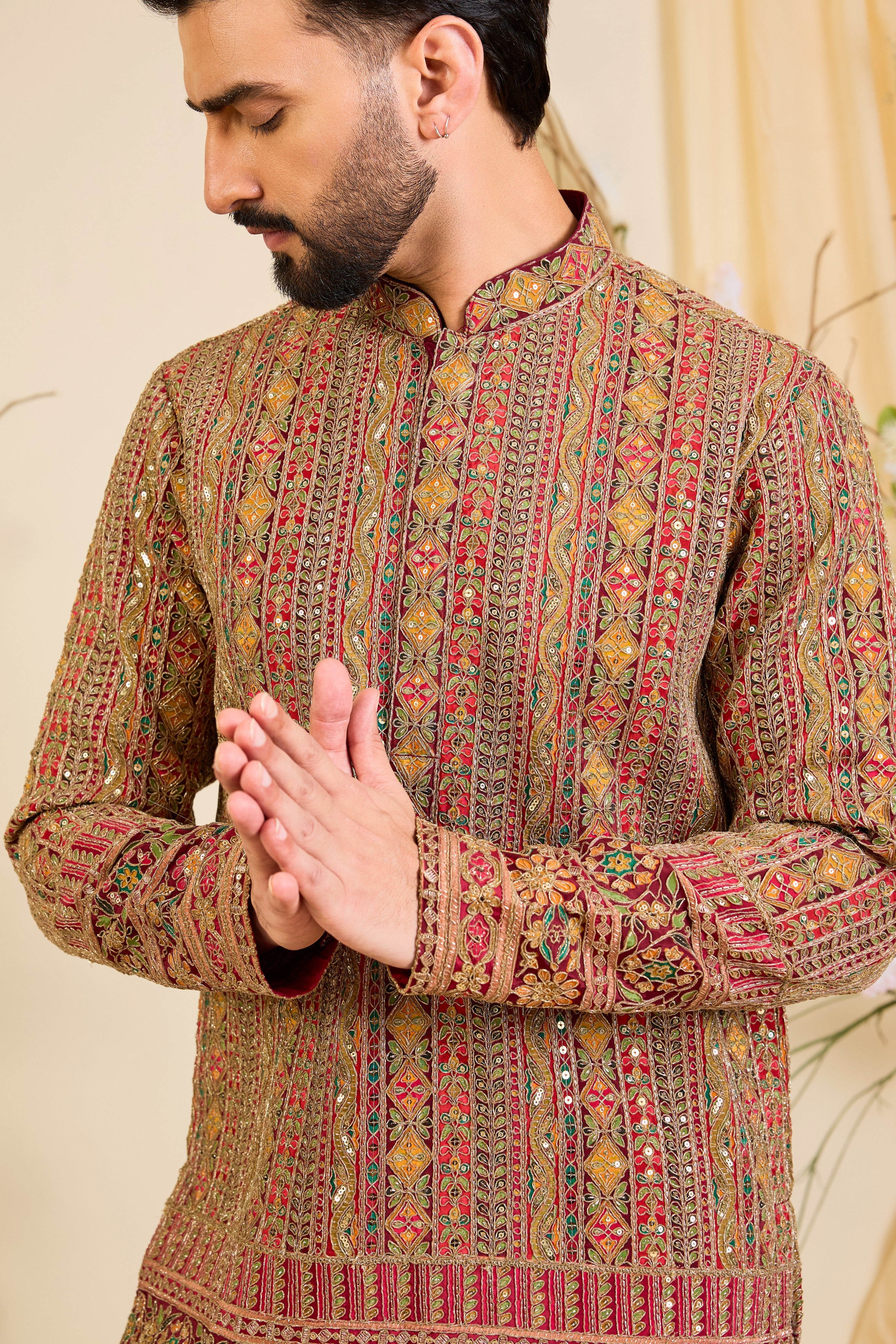 Pink base short kurta with heavy zari embroidery, intricate sequins, and multicolour prints, crafted for bold, opulent, statement-making occasions.