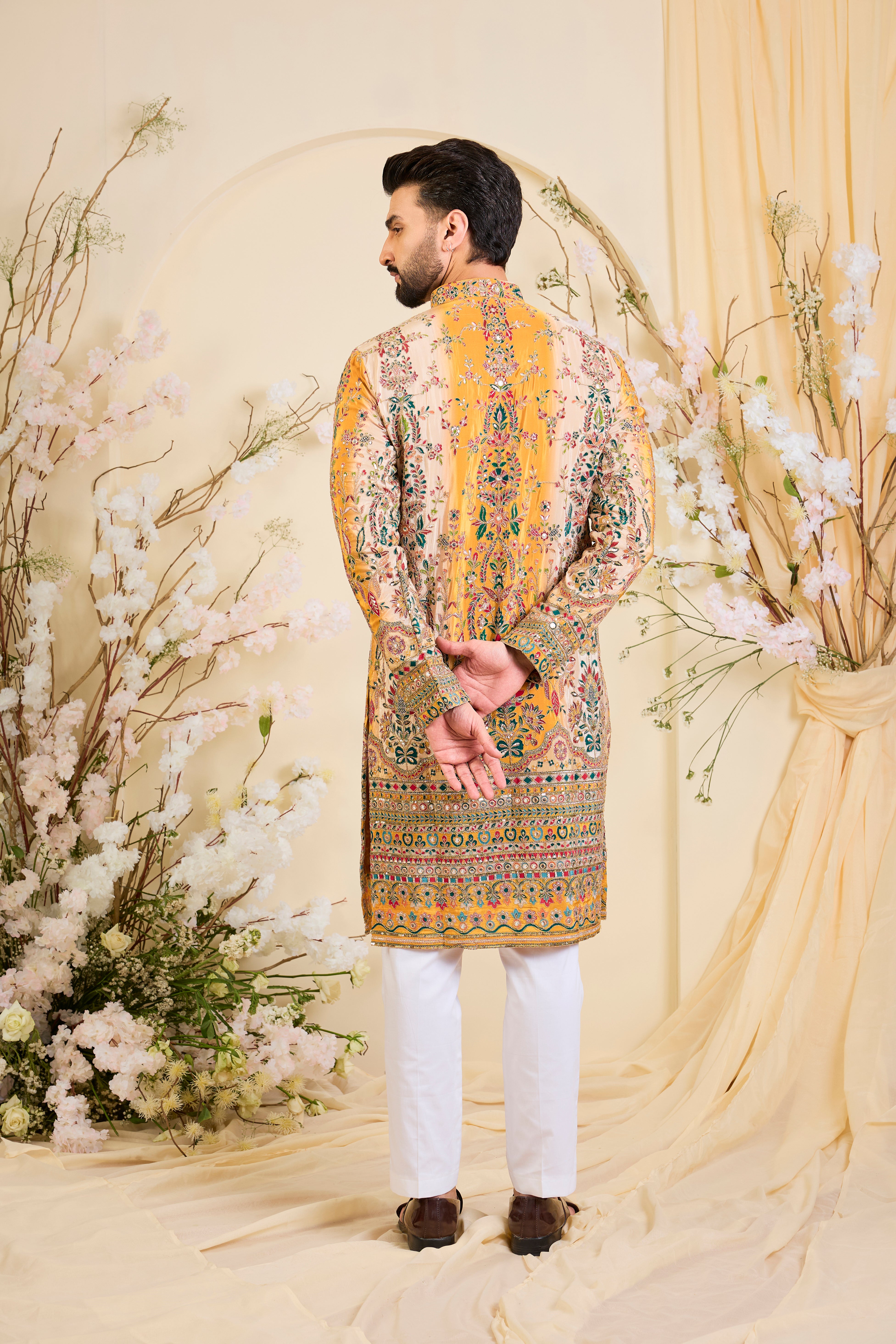 Green crepe kurta with intricate zari work, vibrant multicolour prints, and refined sequin detailing.