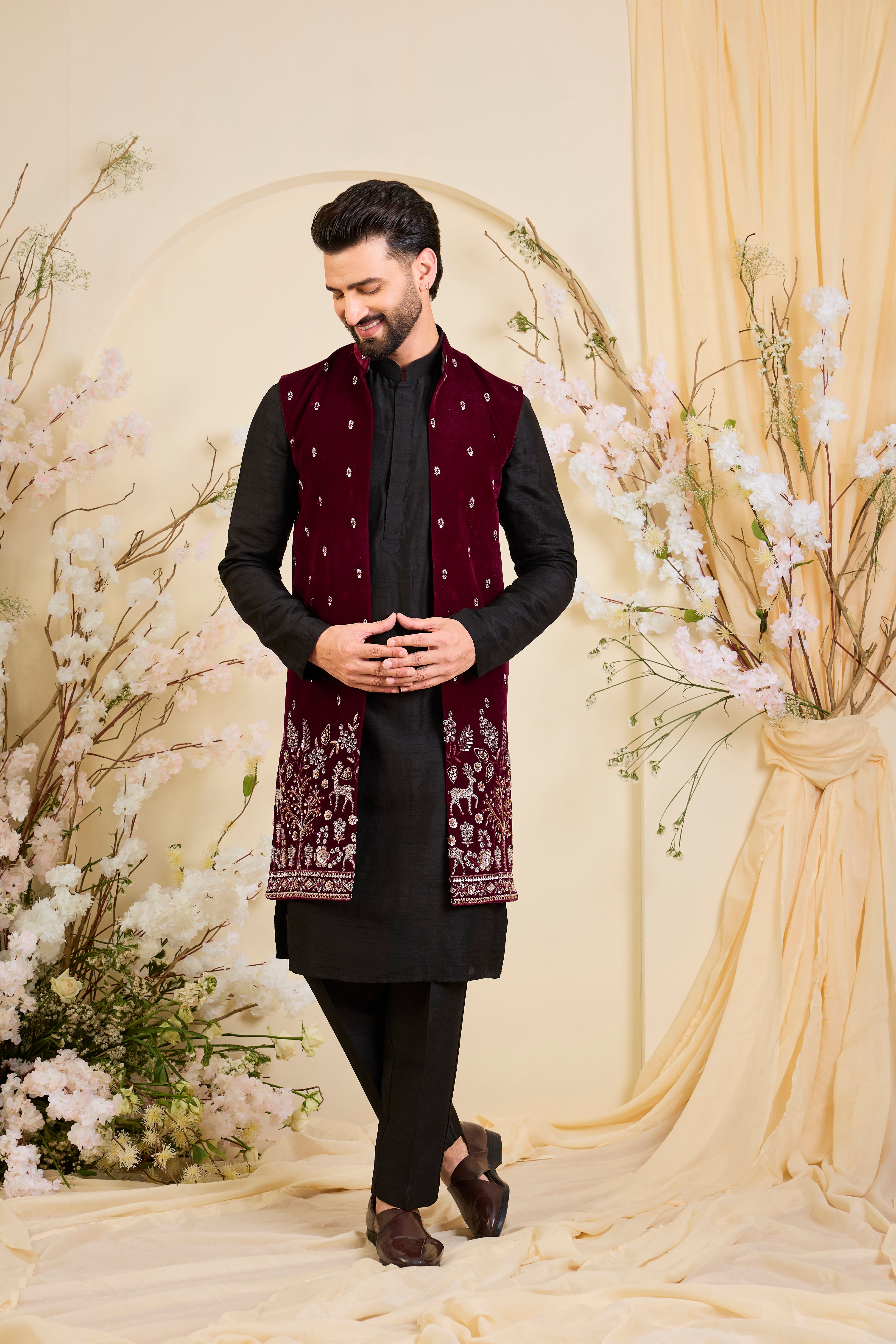 An opulent maroon long open , intricately hand-embroidered with dense cut dana work and elaborate flora-fauna motifs, exuding regal depth and grand sophistication.