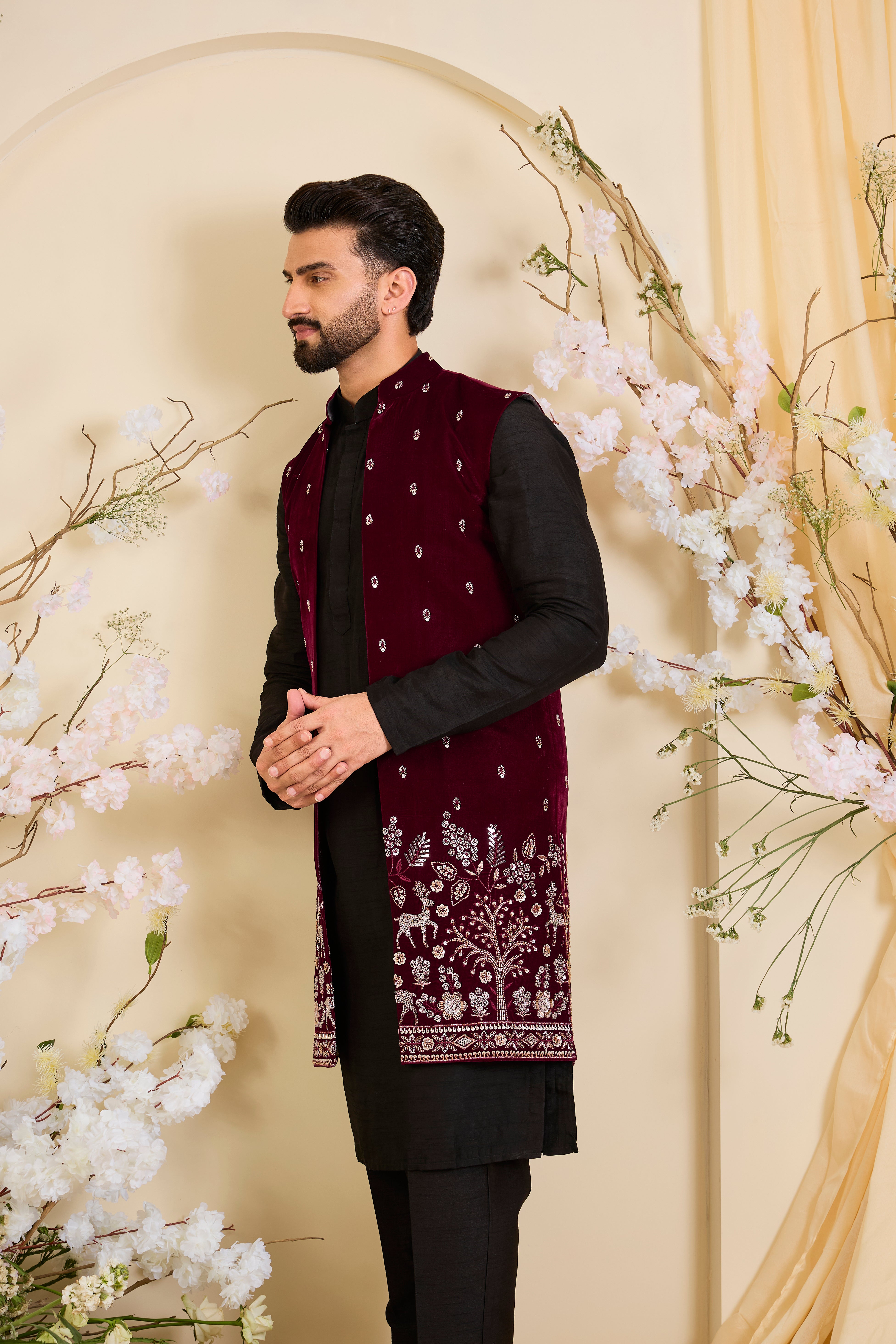 An opulent maroon long open , intricately hand-embroidered with dense cut dana work and elaborate flora-fauna motifs, exuding regal depth and grand sophistication.