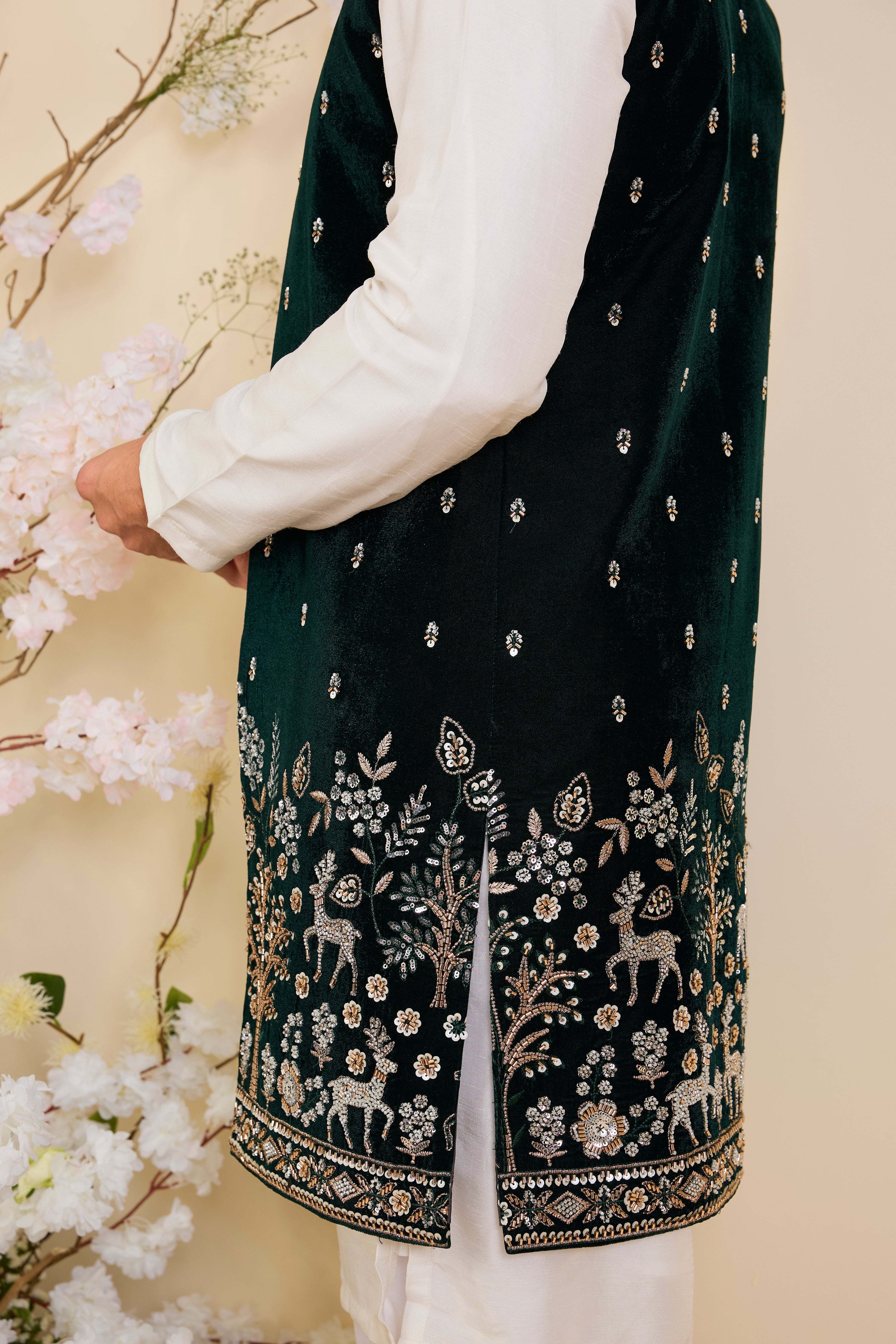 An opulent bottle green long open , intricately hand-embroidered with dense cut dana work and elaborate flora-fauna motifs, exuding regal depth and grand sophistication.