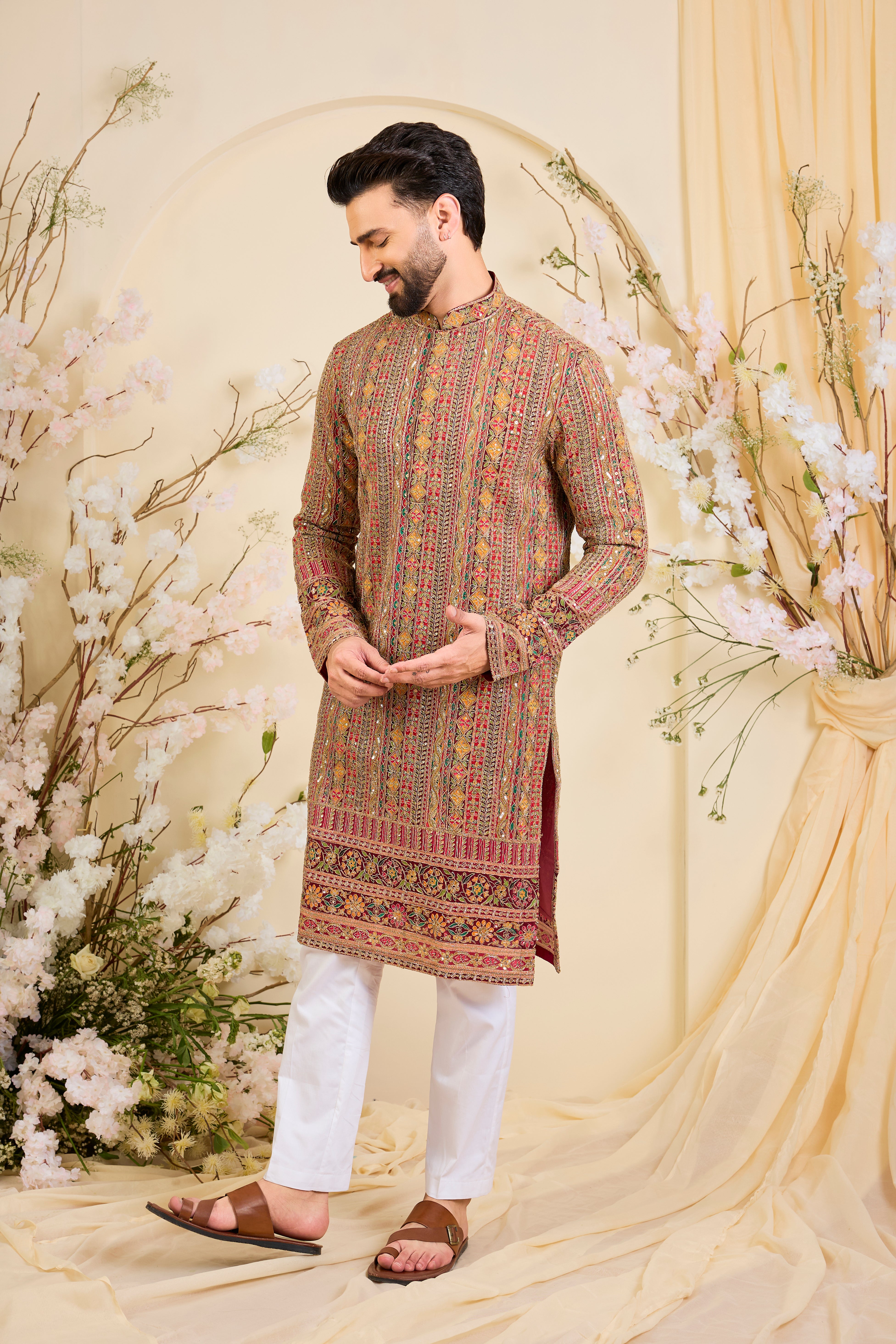 Pink base kurta with heavy zari embroidery, intricate sequins, and multicolour prints, crafted for bold, opulent, statement-making occasions.