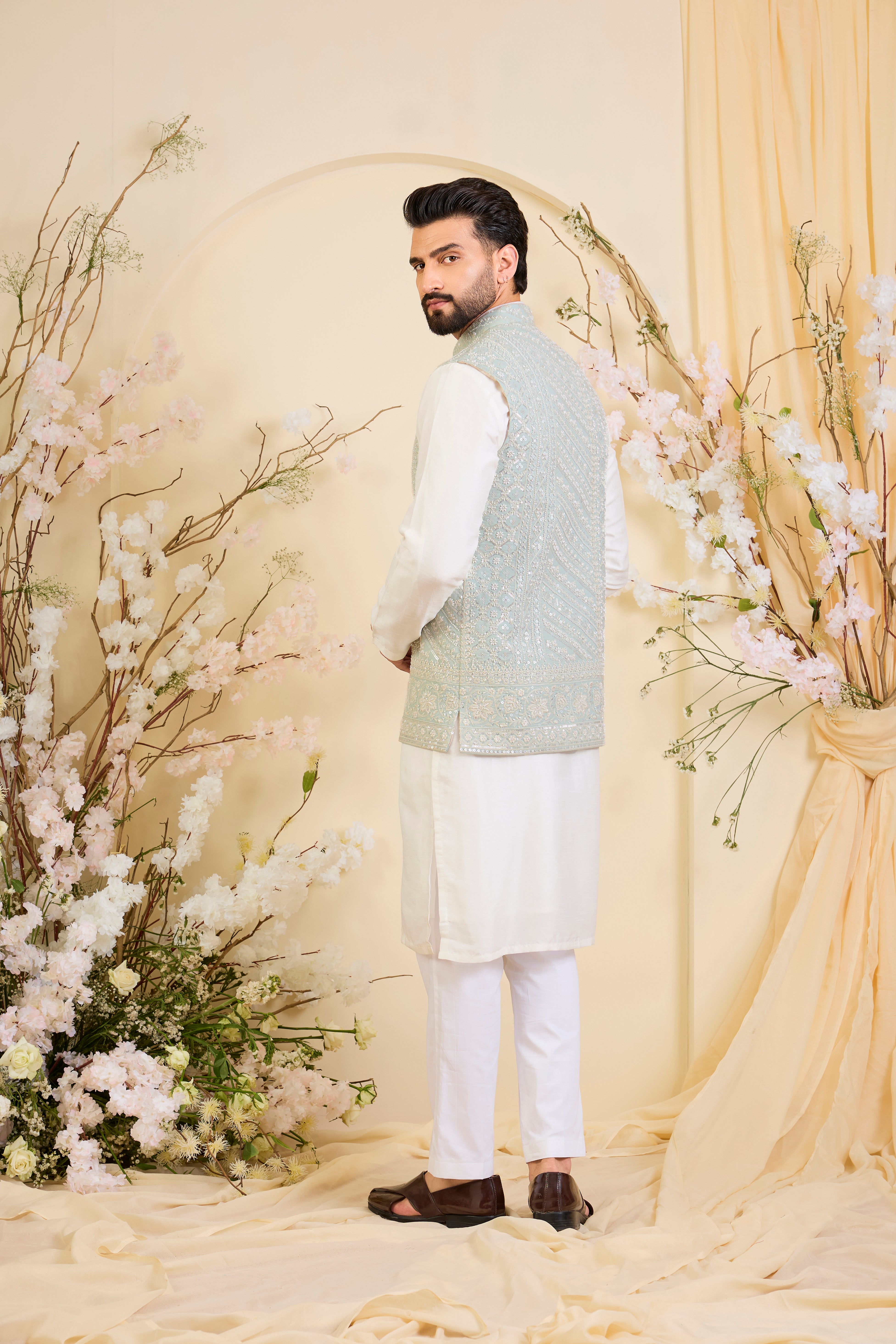 Powder blue Nehru jacket with hand embroidery and delicate ivory cut dana work, offering a soft, luminous, and refined couture expression.