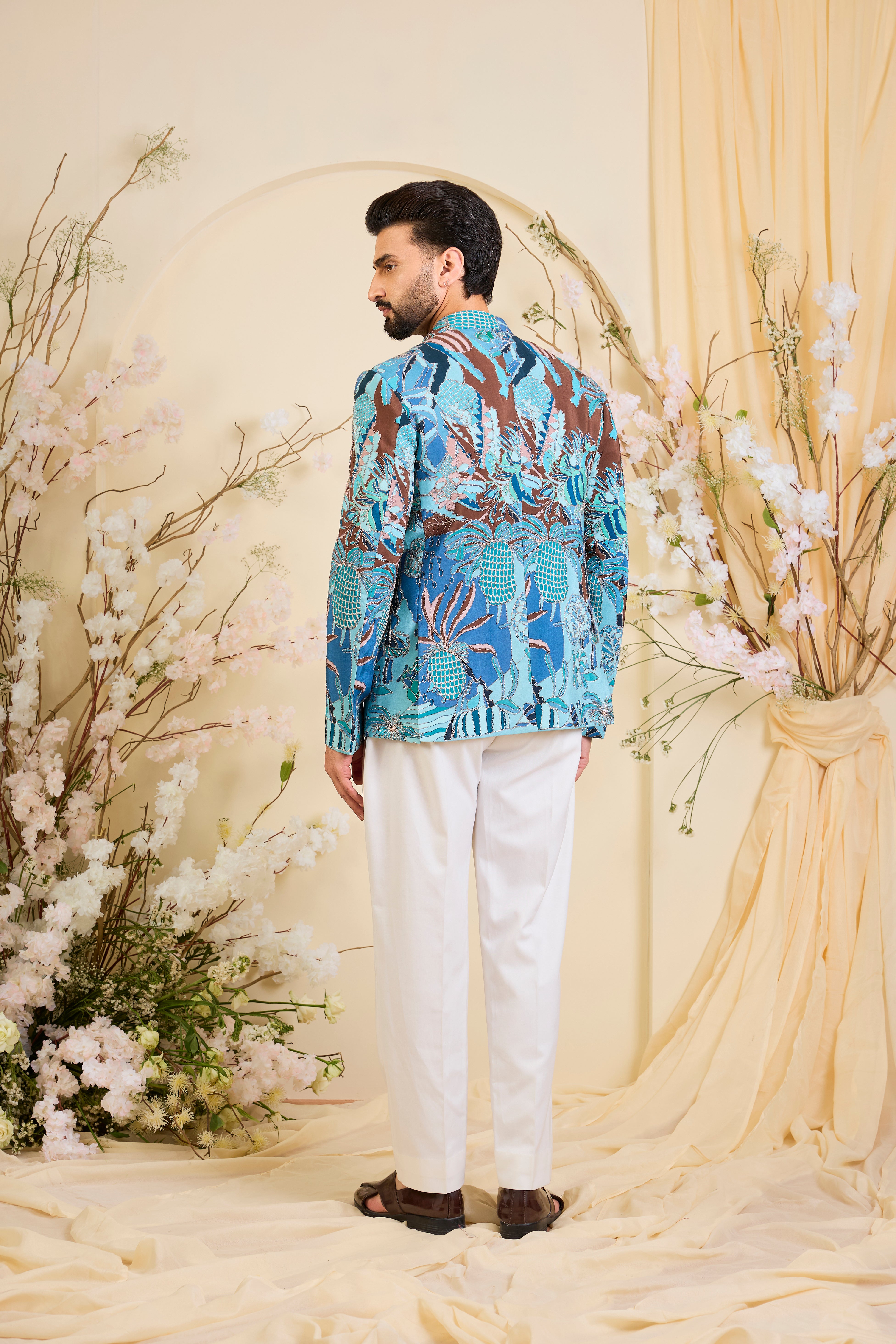 Blue abstract bandhgala with detailed multicolour prints and intricate zari accents, blending artistic expression with refined, modern elegance.