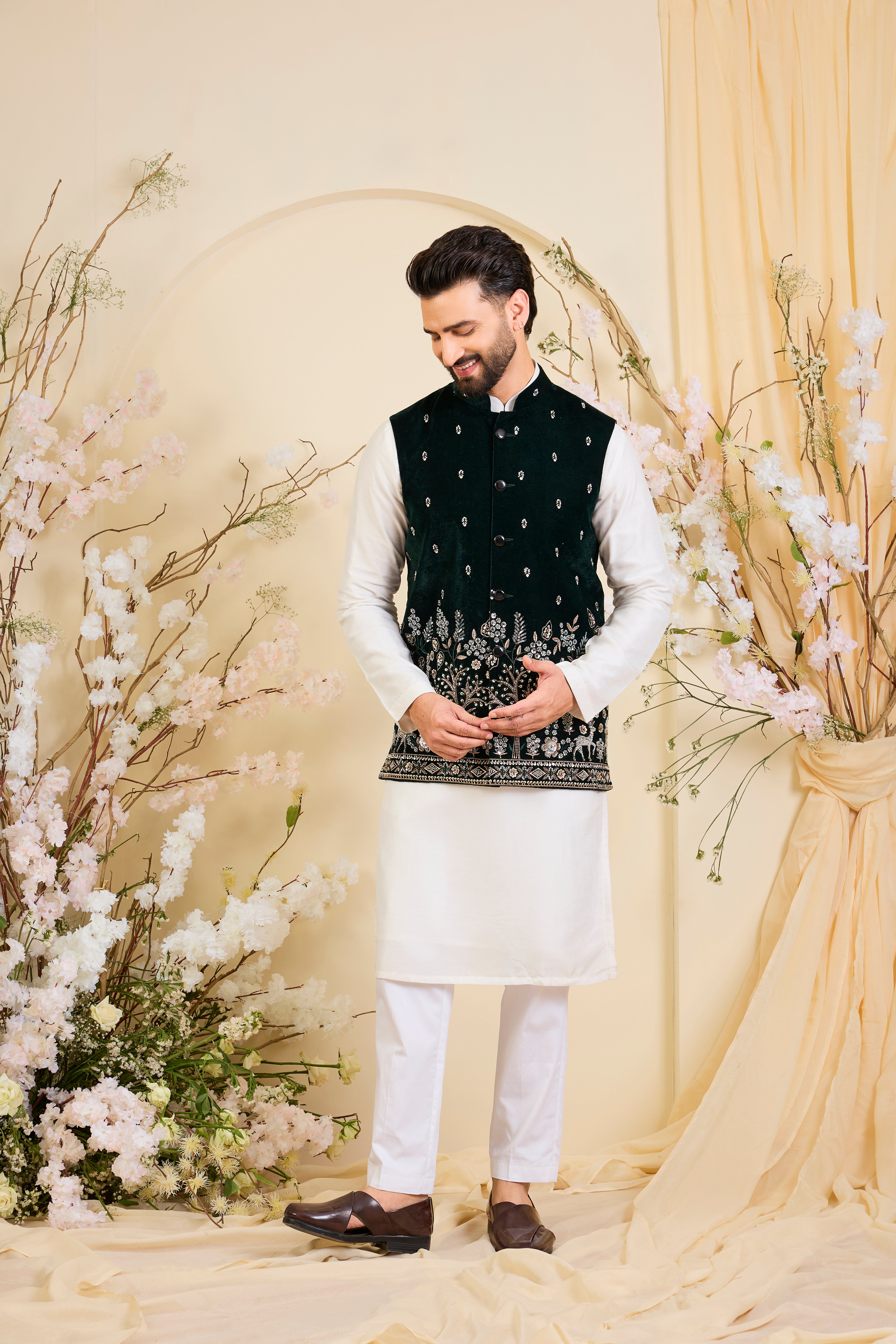 An opulent bottle green nehru jacket , intricately hand-embroidered with dense cut dana work and elaborate flora-fauna motifs, exuding regal depth and grand sophistication.