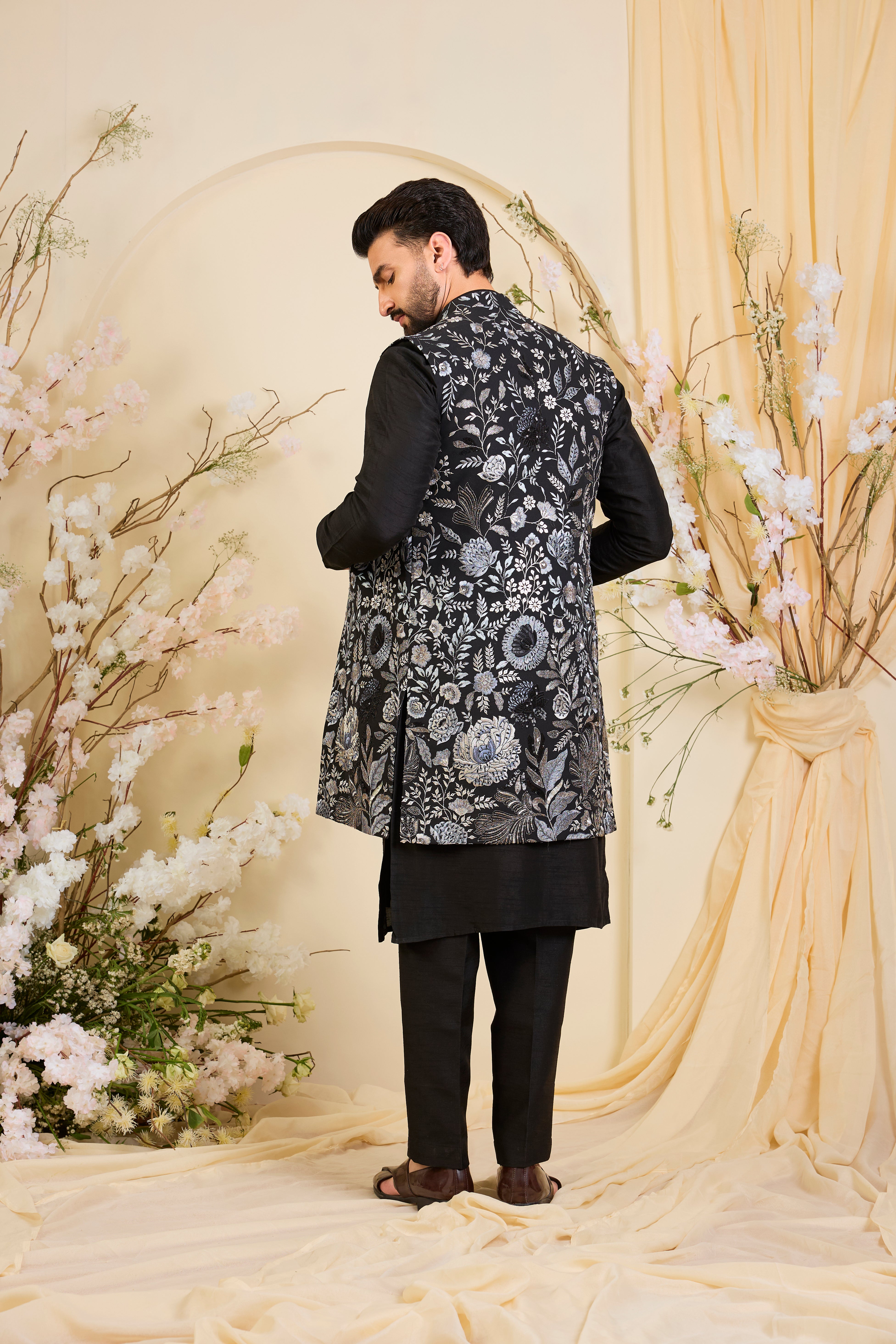 Black long open jacket with intricate floral patterns in grey-blue threadwork, elevated by detailed sequin embellishments for a refined, statement look.