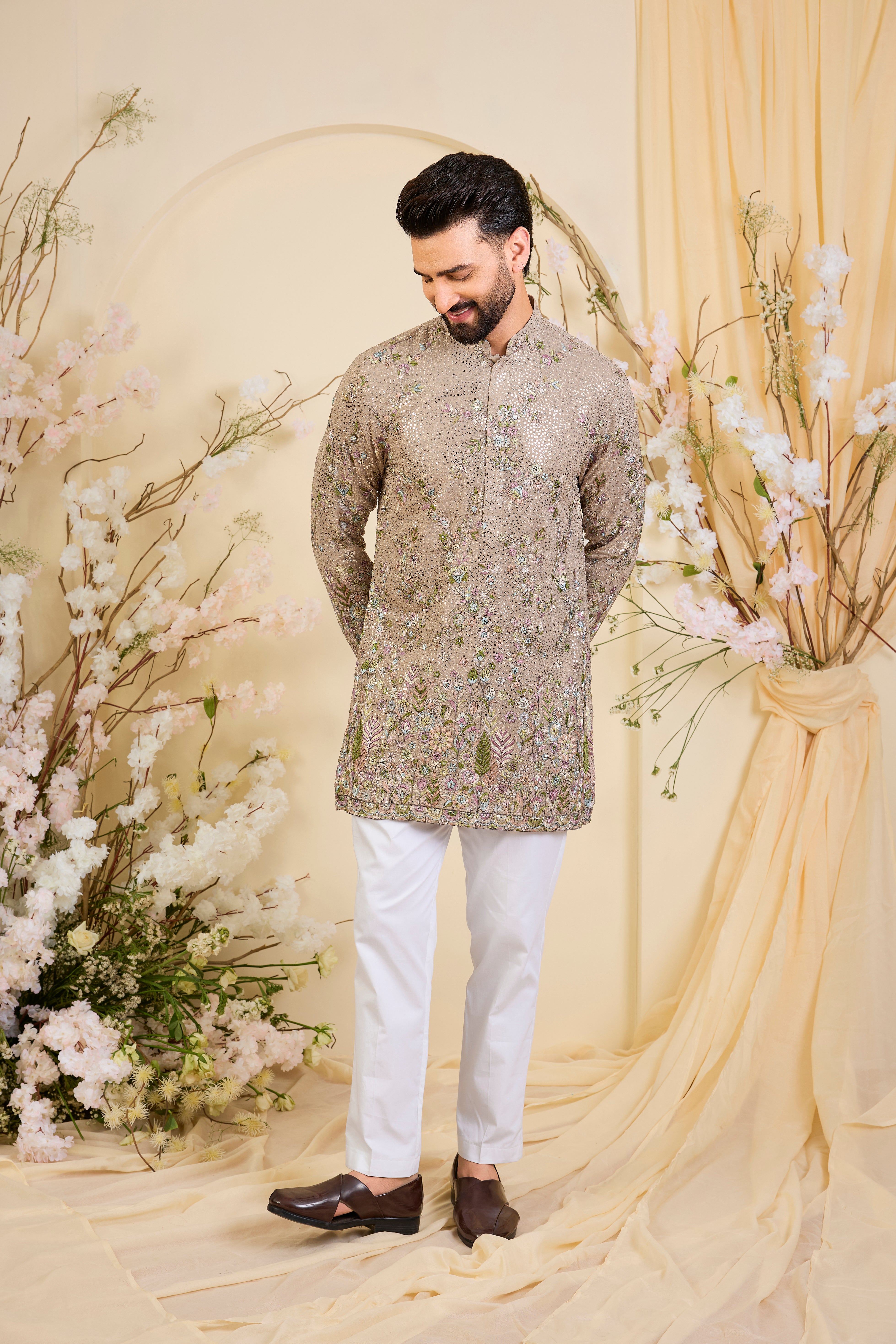 Mouse-toned short kurta with a sequined base, detailed floral embroidery in multicolour threadwork, and heavy sequin detailing for luminous elegance.