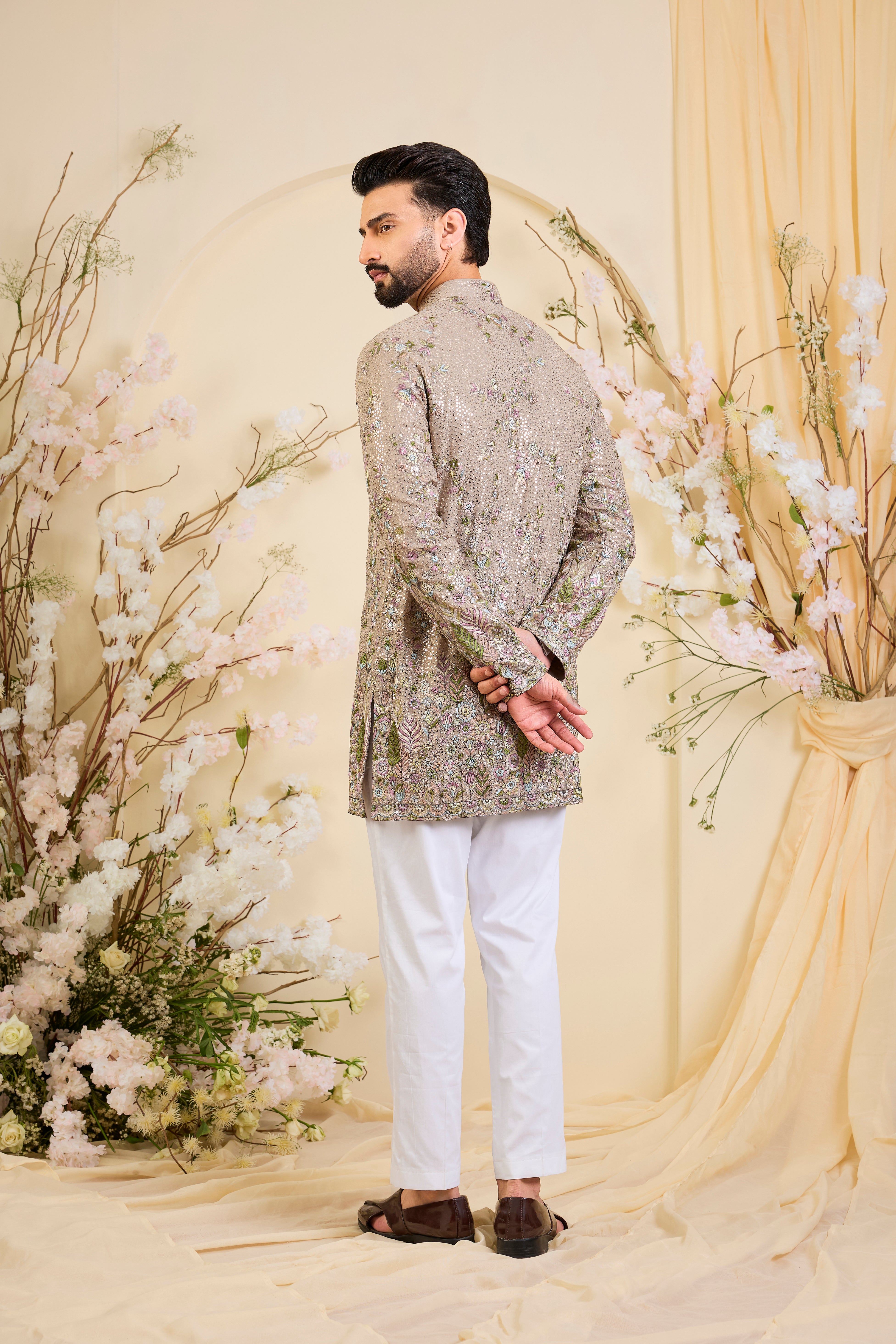 Mouse-toned short kurta with a sequined base, detailed floral embroidery in multicolour threadwork, and heavy sequin detailing for luminous elegance.