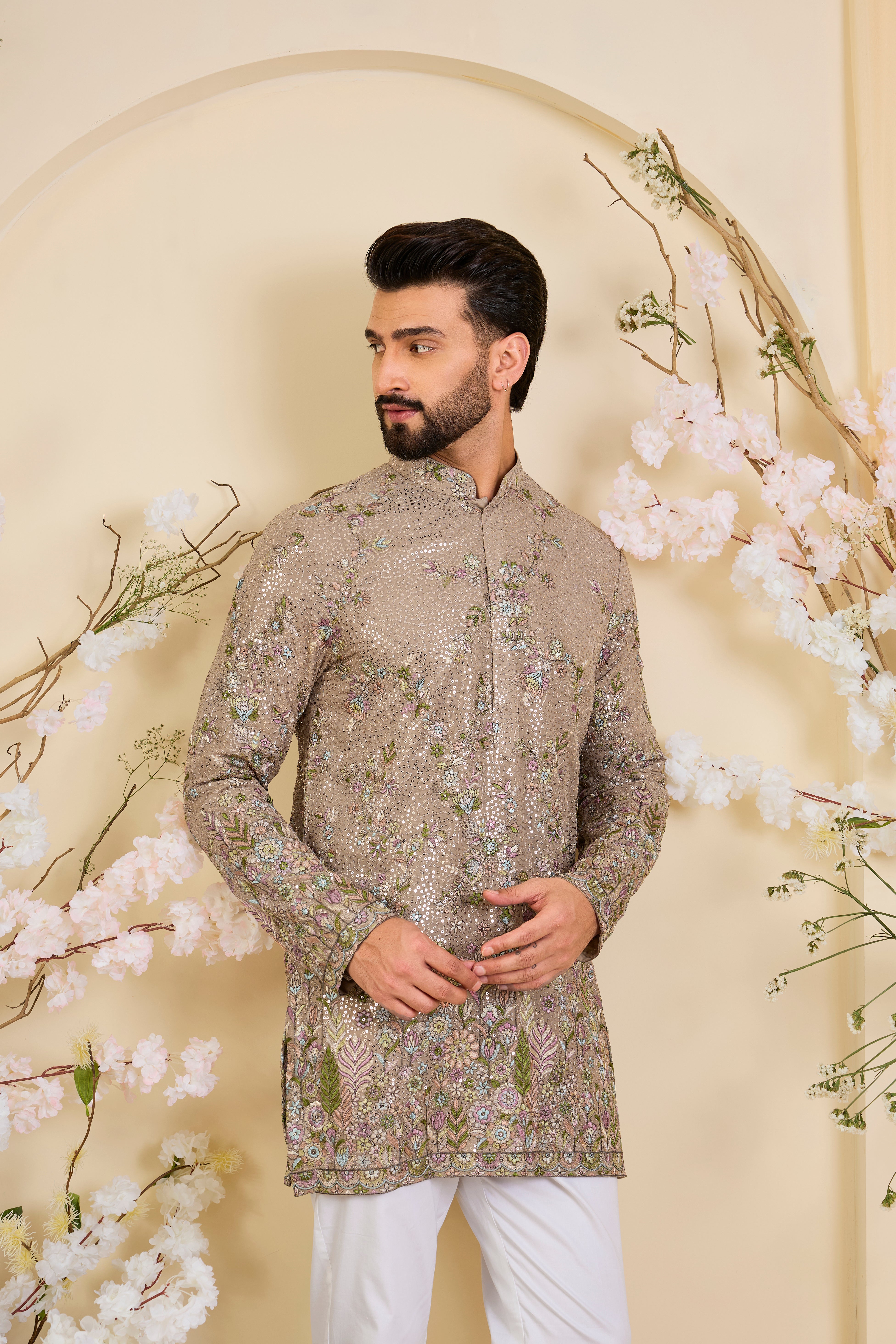 Mouse-toned short kurta with a sequined base, detailed floral embroidery in multicolour threadwork, and heavy sequin detailing for luminous elegance.