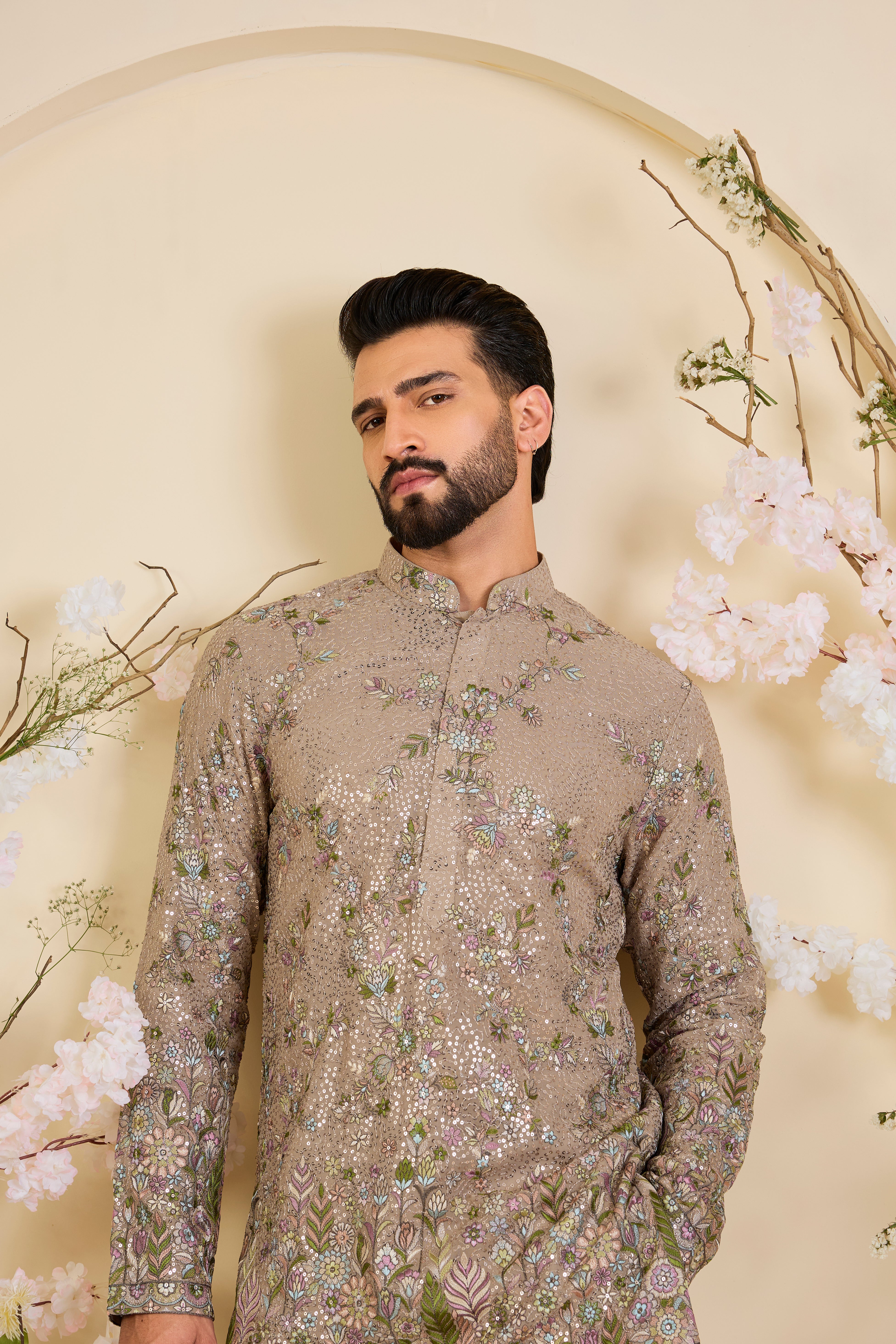Mouse-toned short kurta with a sequined base, detailed floral embroidery in multicolour threadwork, and heavy sequin detailing for luminous elegance.