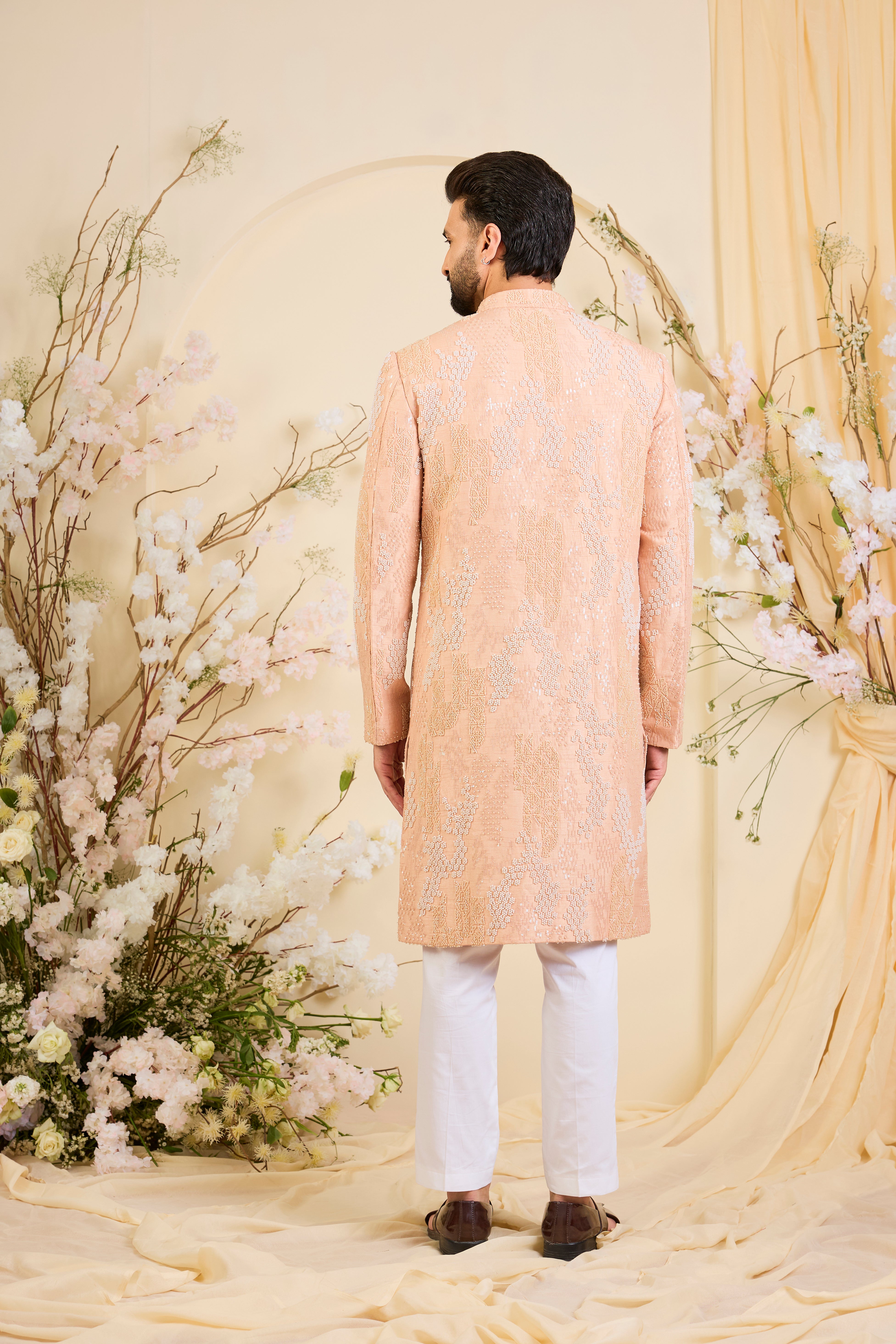 Peach hand-embroidered sherwani with tonal peach and ivory cut dana work, offering a refined, luminous, and impeccably formal couture statement.