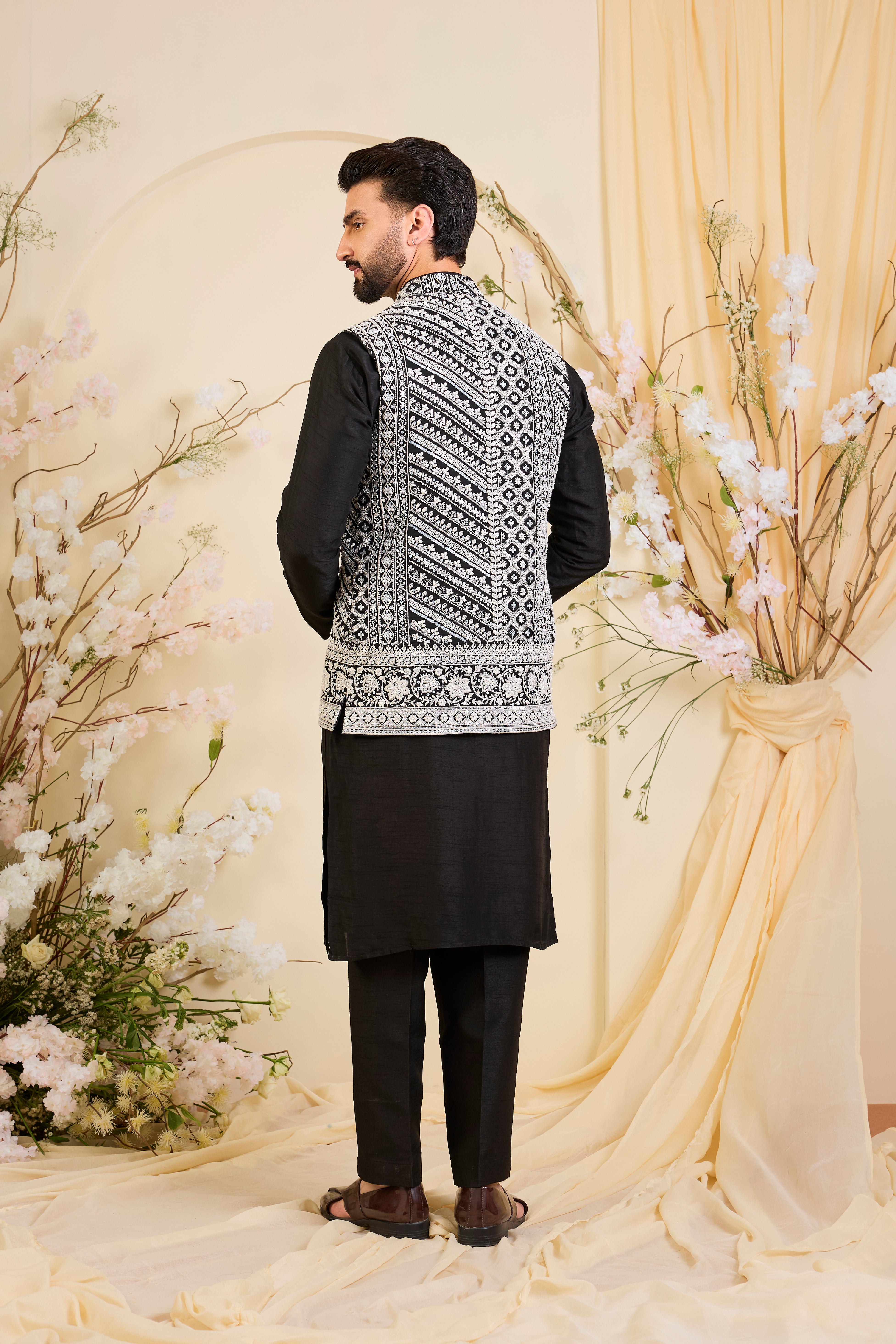 Black Nehru jacket with hand embroidery and delicate ivory cut dana work, offering a luminous, and refined couture expression.