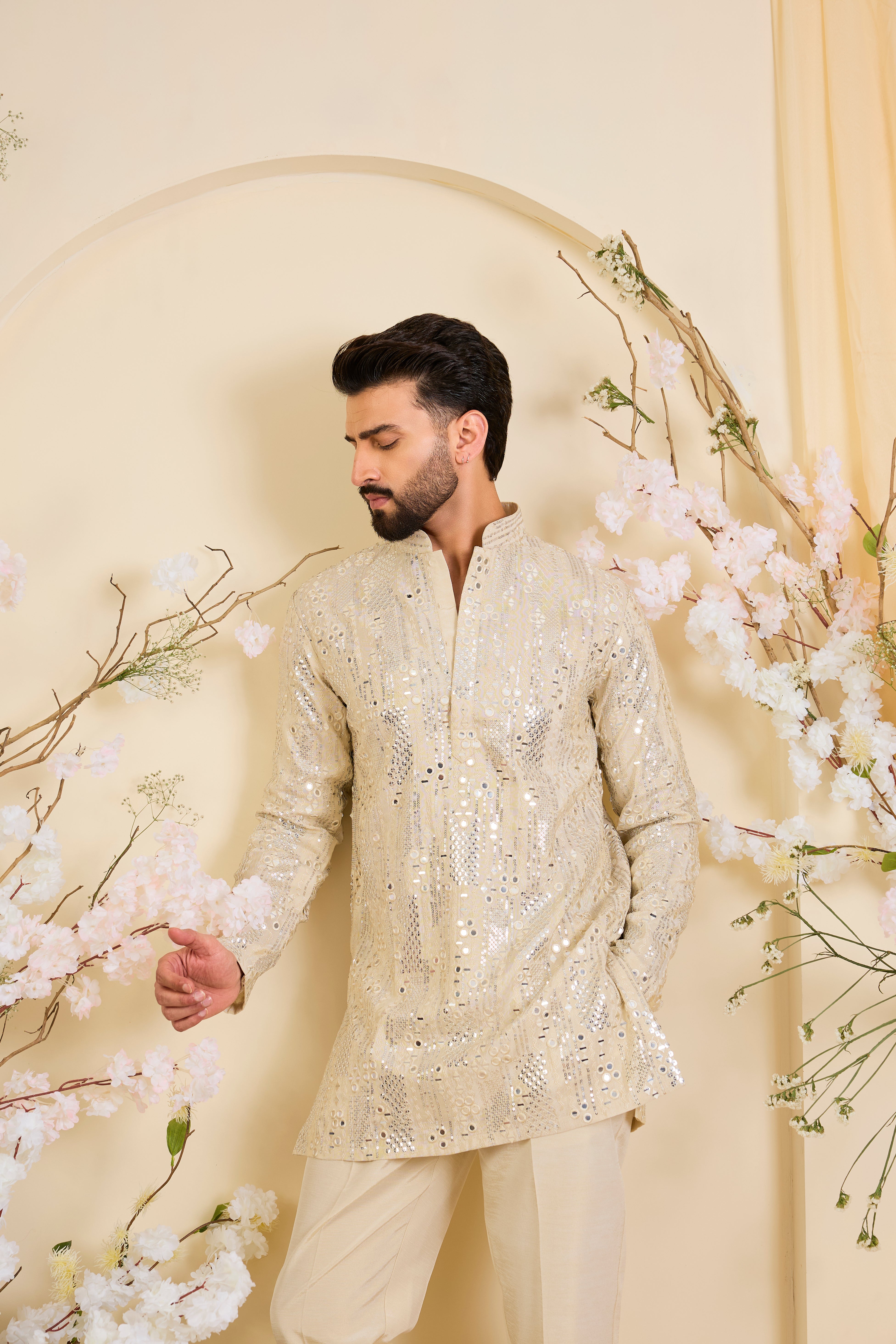 Crafted in luminous tissue, this golden short kurta is intricately detailed with sequin mirrorwork, creating a refined illusion of traditional mirrors.