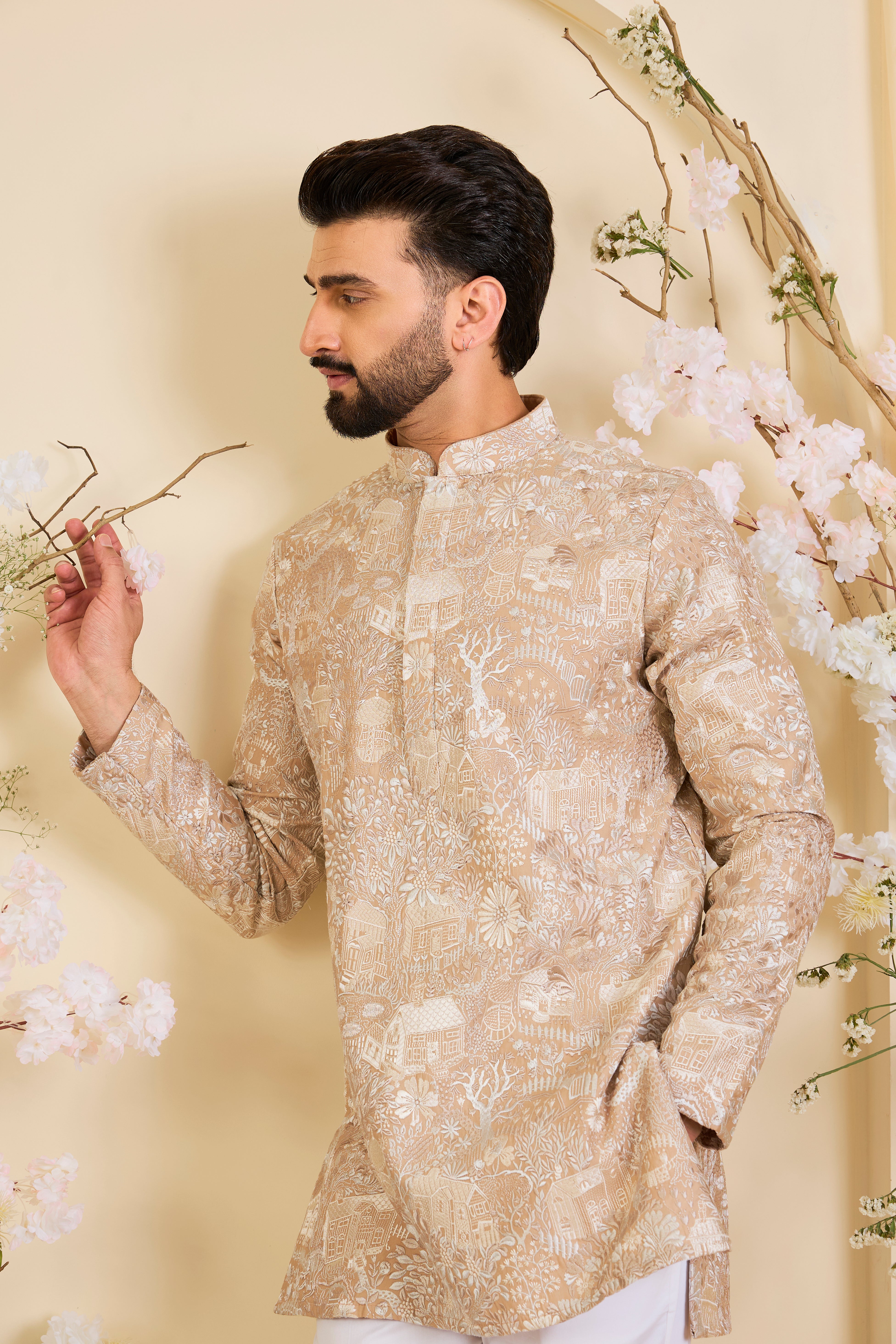 Dark beige/ dust pink short kurta with intricate flora-fauna embroidery and dense threadwork, offering a refined, richly textured couture statement.