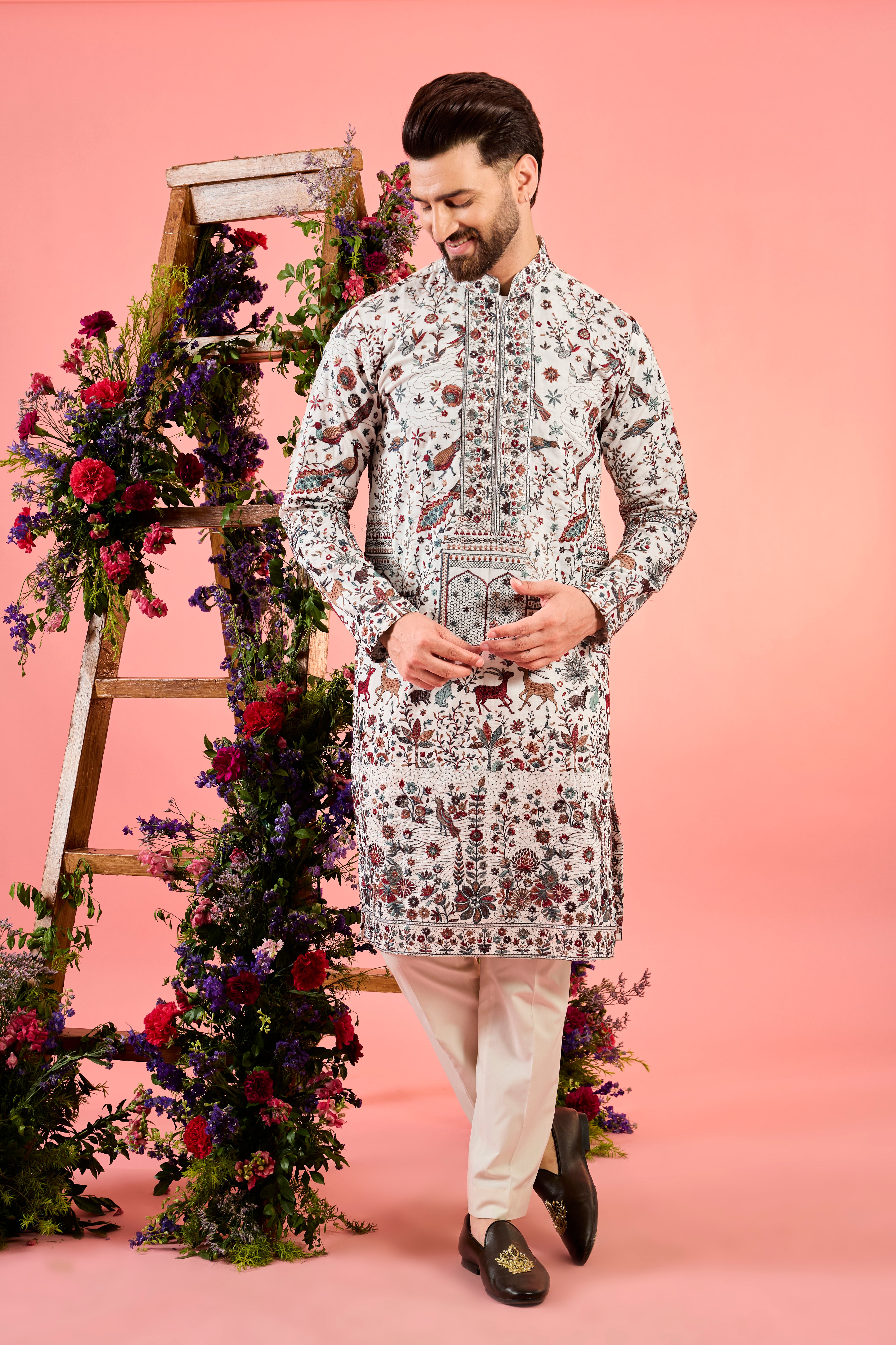 white chikankari kurta with deatiled flora & fauna and intricate neckline