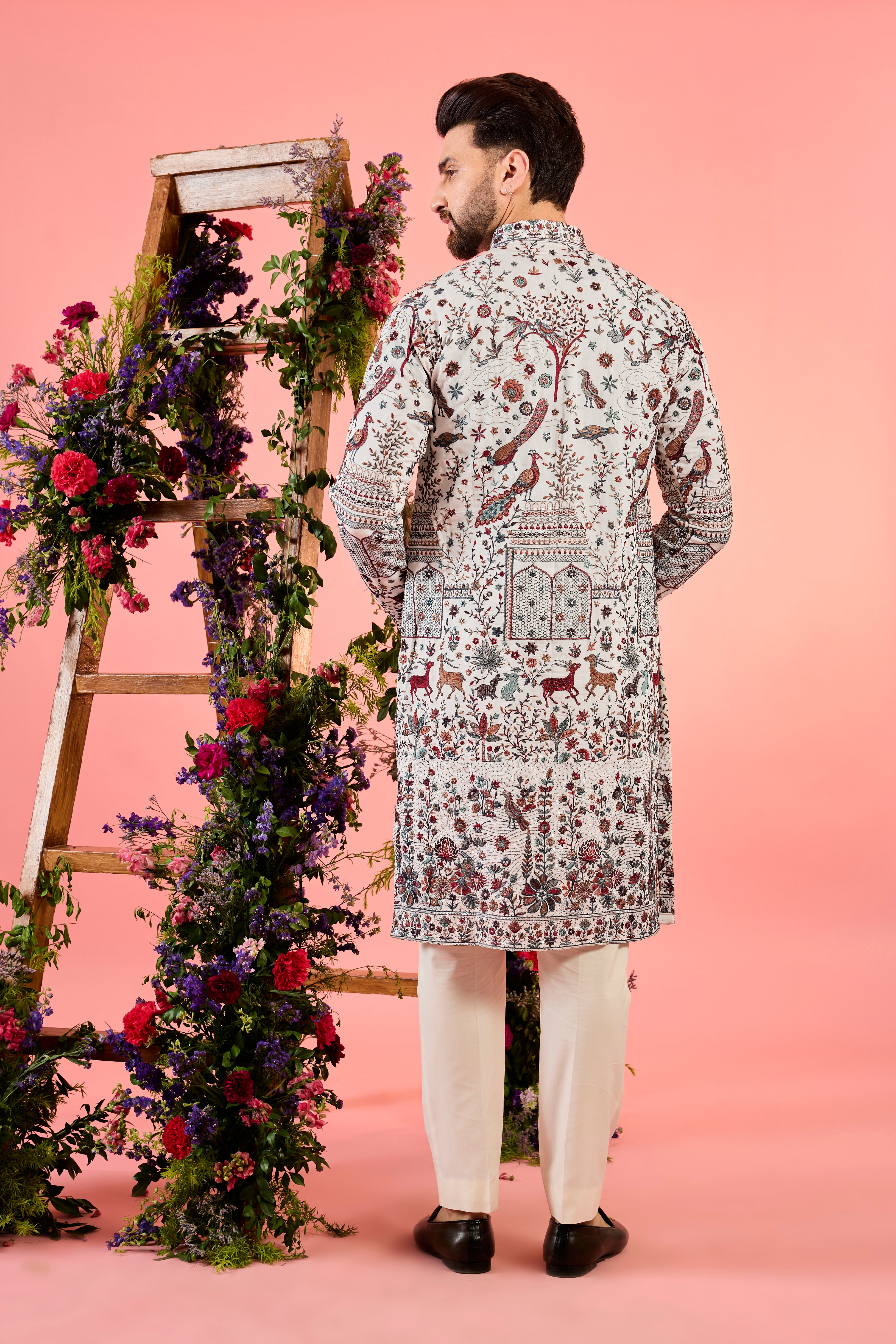 white chikankari kurta with deatiled flora & fauna and intricate neckline