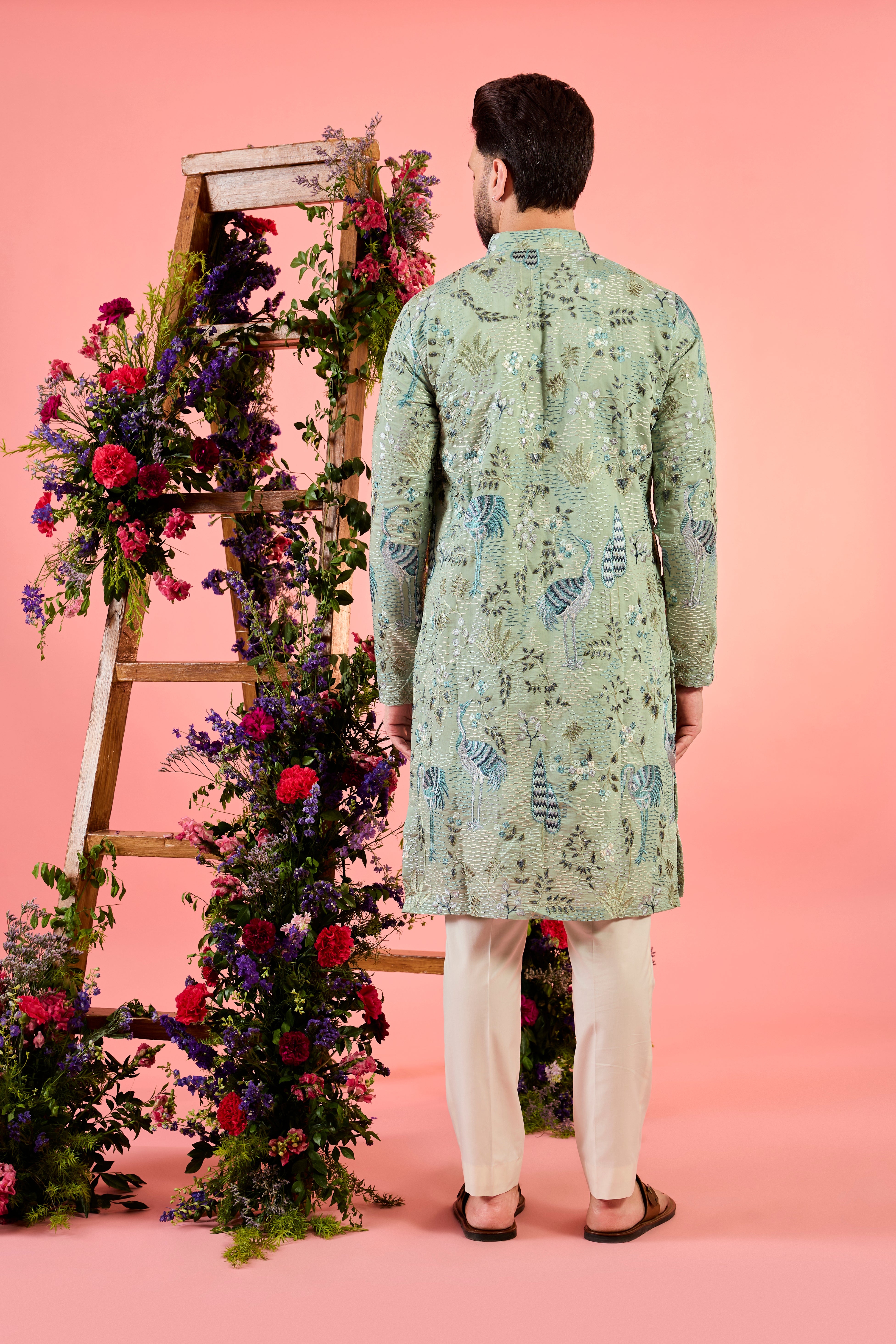 mint green thread work kurta with intricate flora and fauna emnroidery