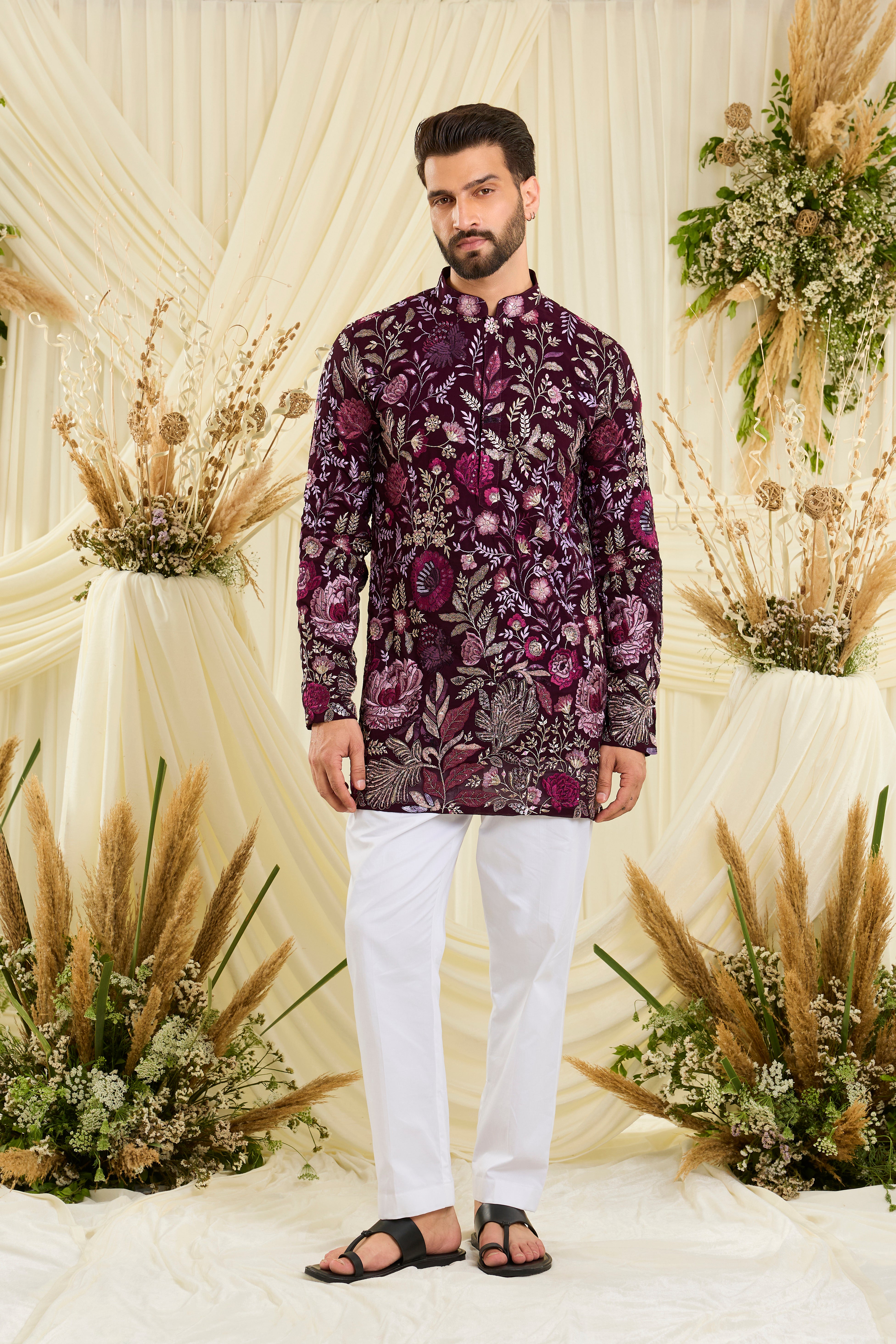 Wine-purple short kurta featuring detailed floral embroidery, delicate zari work, and sequins for a sharp, luxe festive vibe.