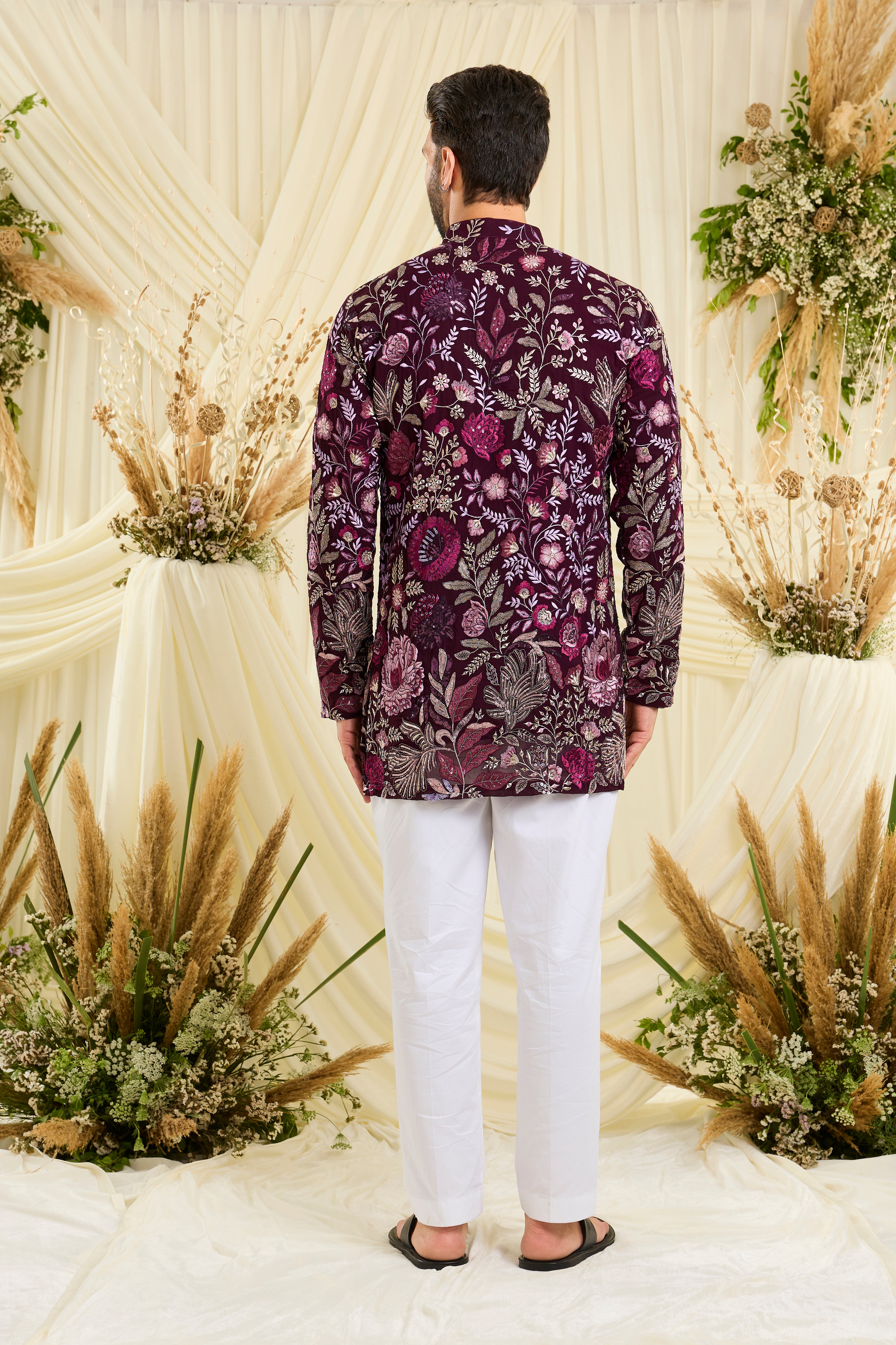 Wine-purple short kurta featuring detailed floral embroidery, delicate zari work, and sequins for a sharp, luxe festive vibe.