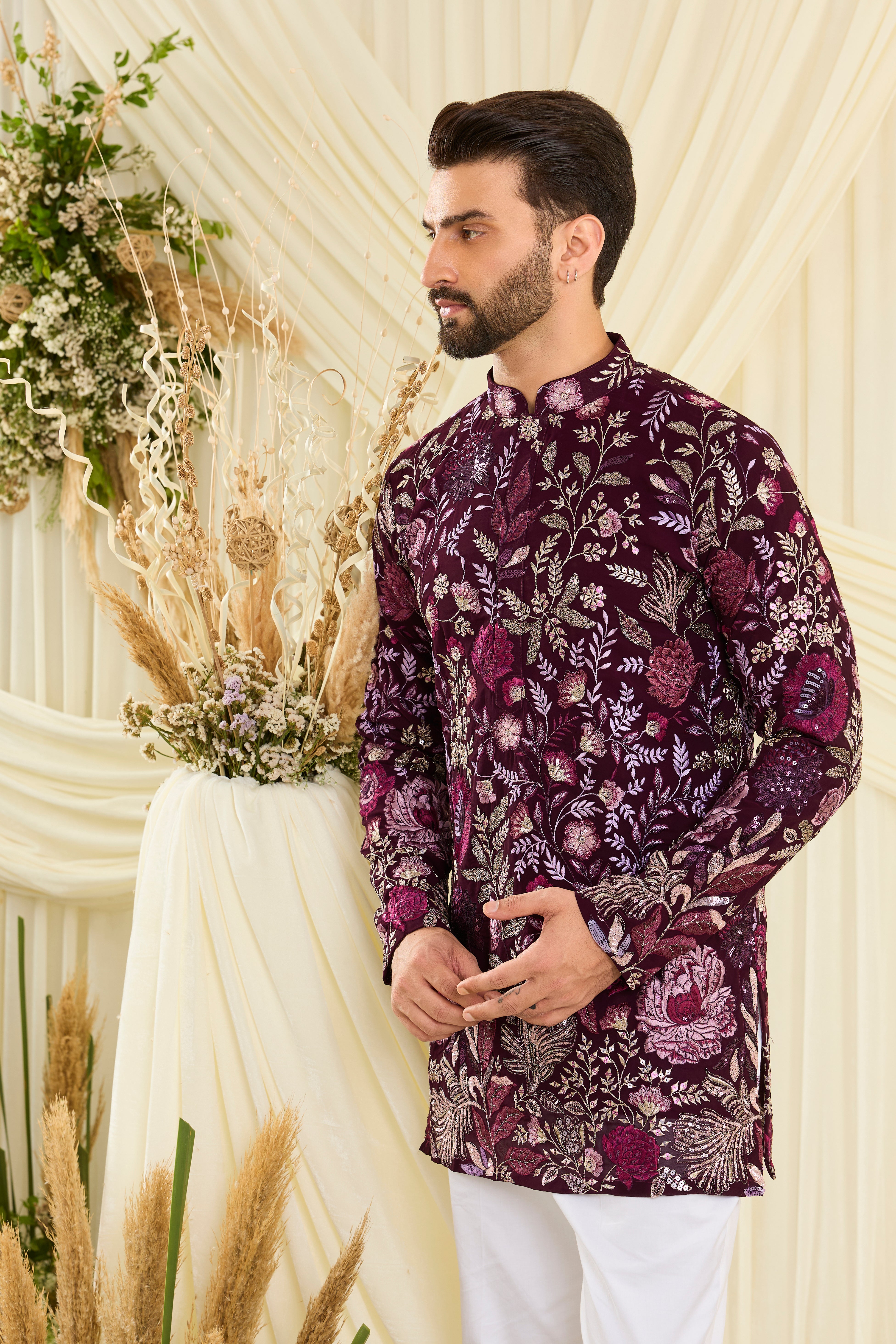 Wine-purple short kurta featuring detailed floral embroidery, delicate zari work, and sequins for a sharp, luxe festive vibe.