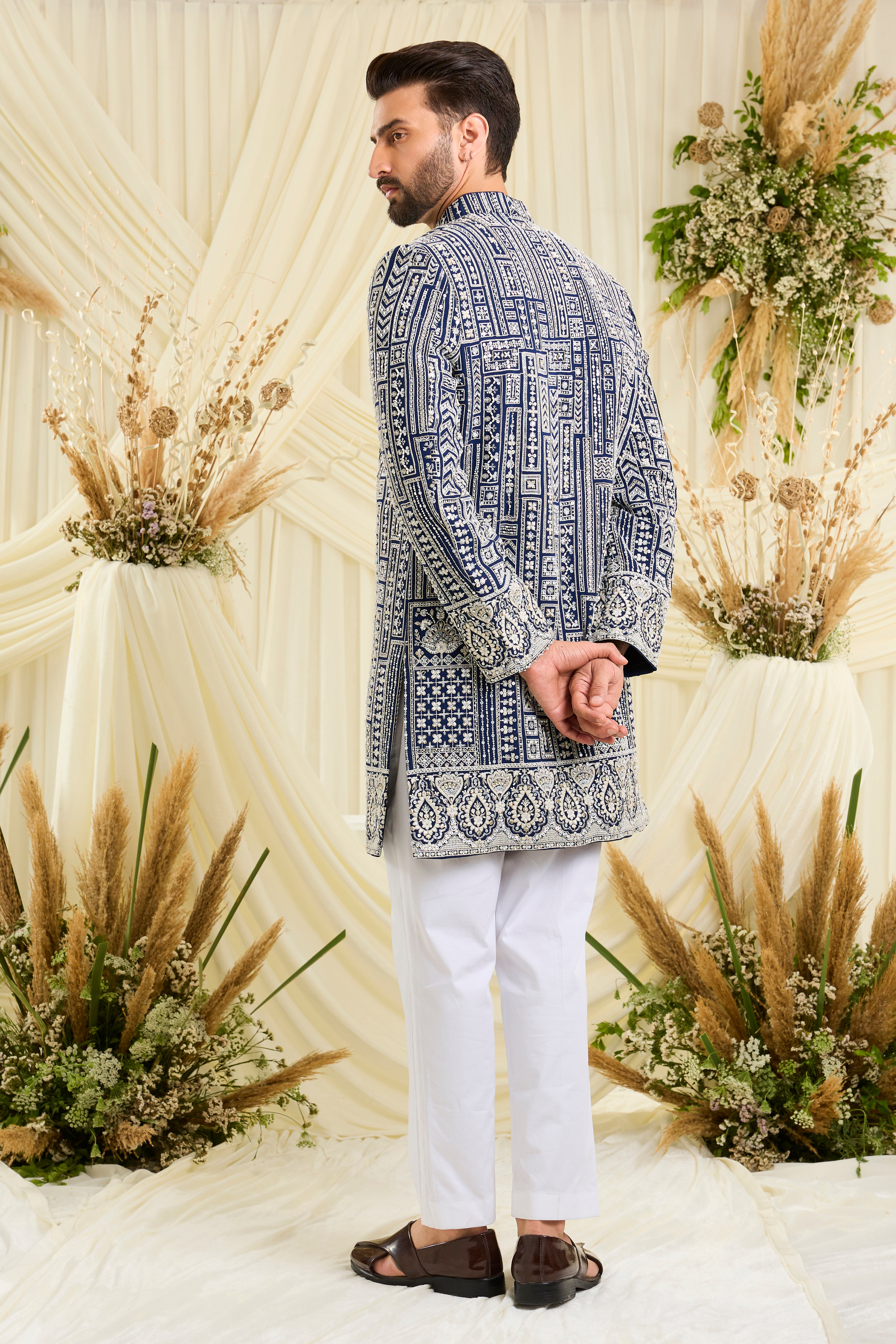 Royal blue short sherwani with intricate white cut dana work and delicate sequins, crafted for a bold, ultra-luxurious statement.