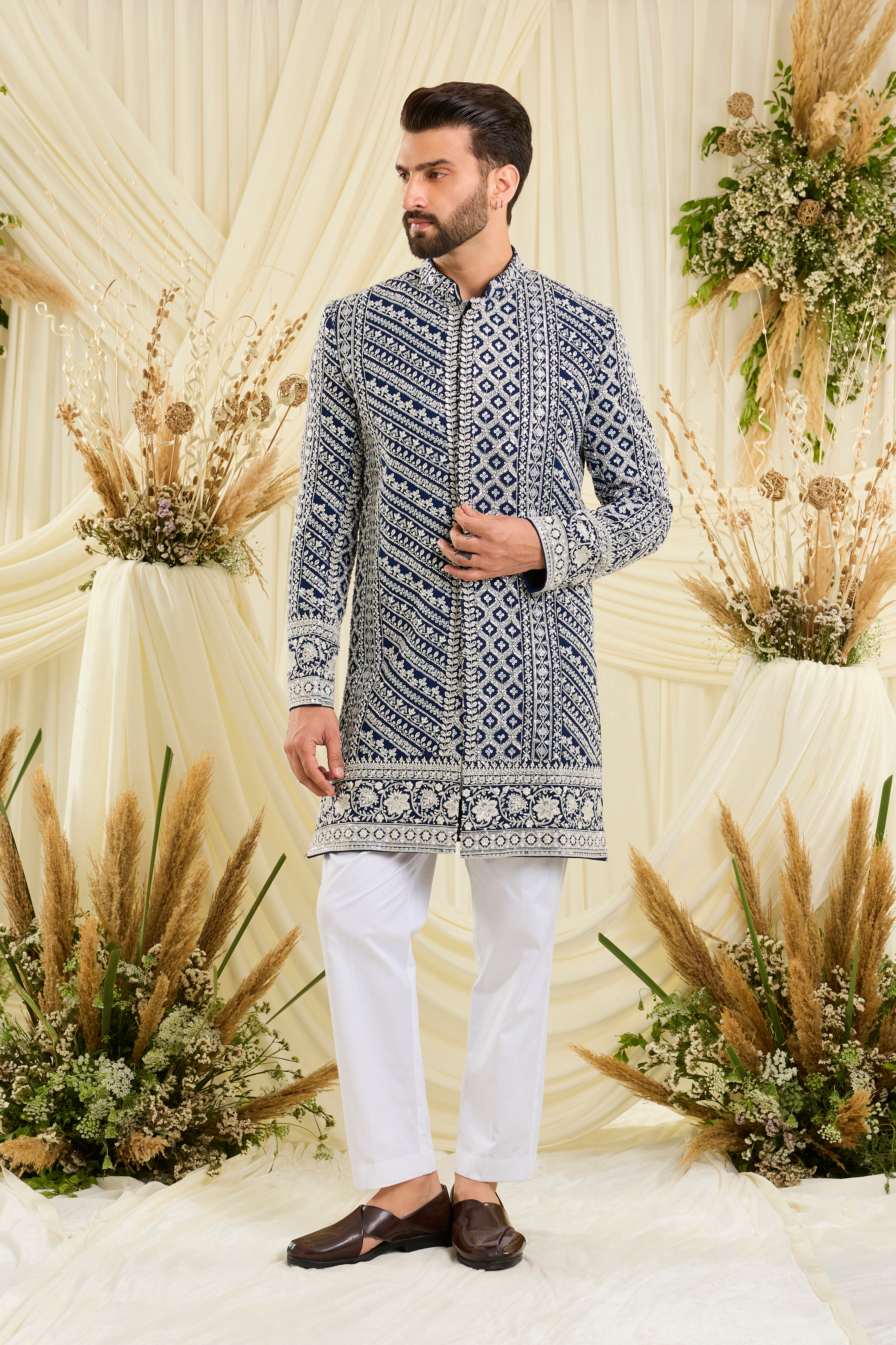 Royal blue short sherwani with intricate white cut dana work and delicate sequins, crafted for a bold, ultra-luxurious statement.