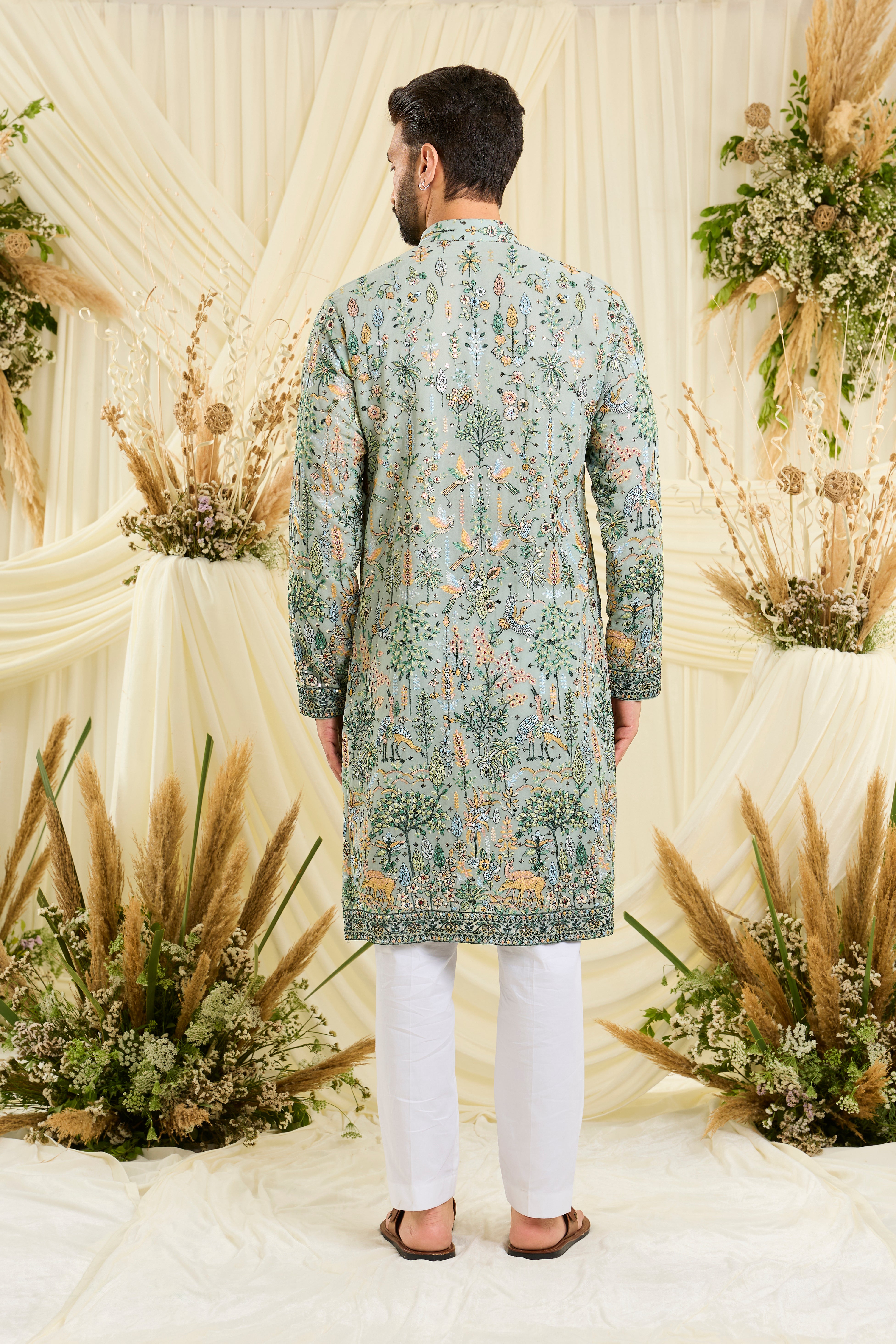 Pastel sage green kurta with intricate flora-fauna embroidery, multicolour threadwork, and delicate sequins for a fresh, elevated festive look.