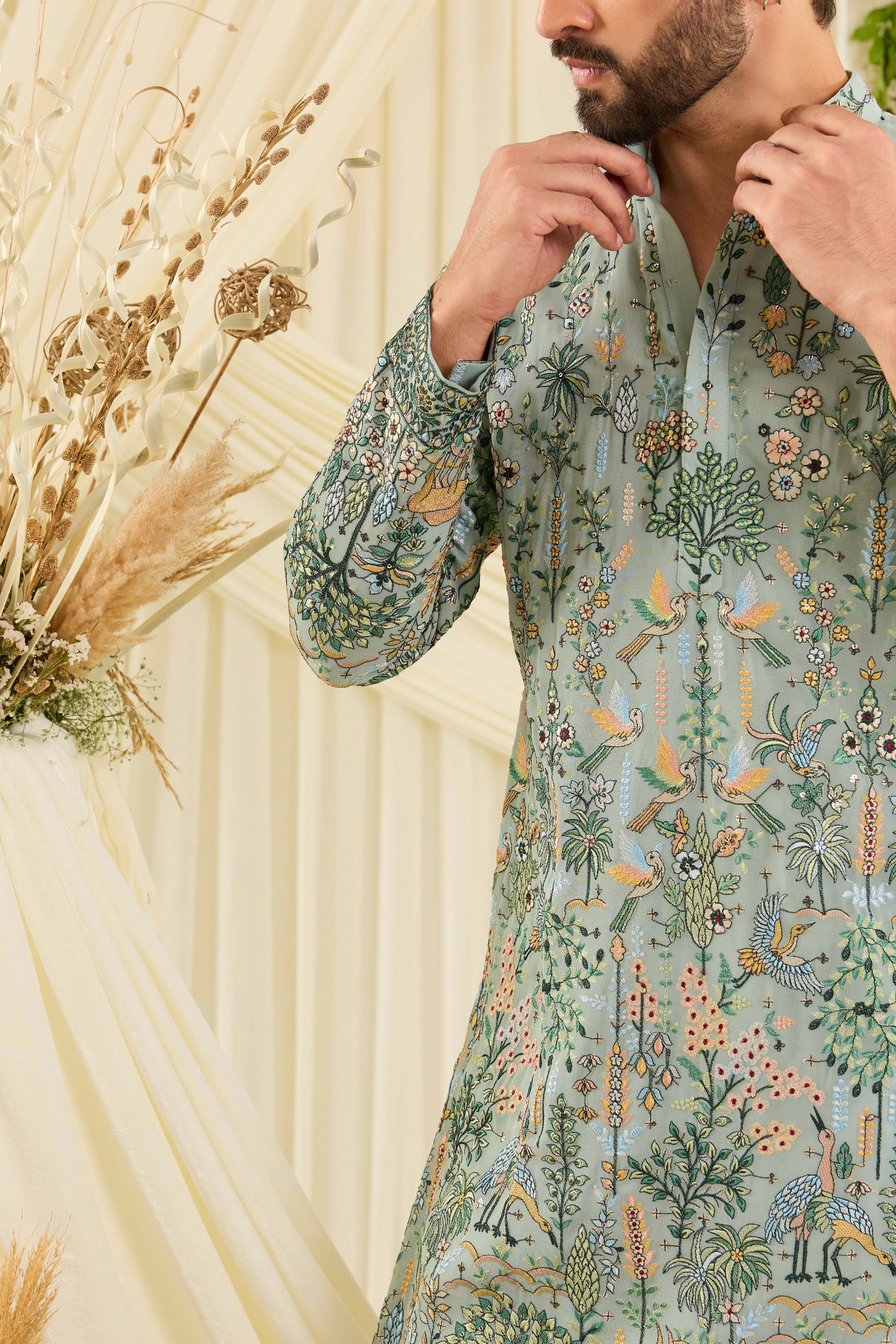 Pastel sage green kurta with intricate flora-fauna embroidery, multicolour threadwork, and delicate sequins for a fresh, elevated festive look.