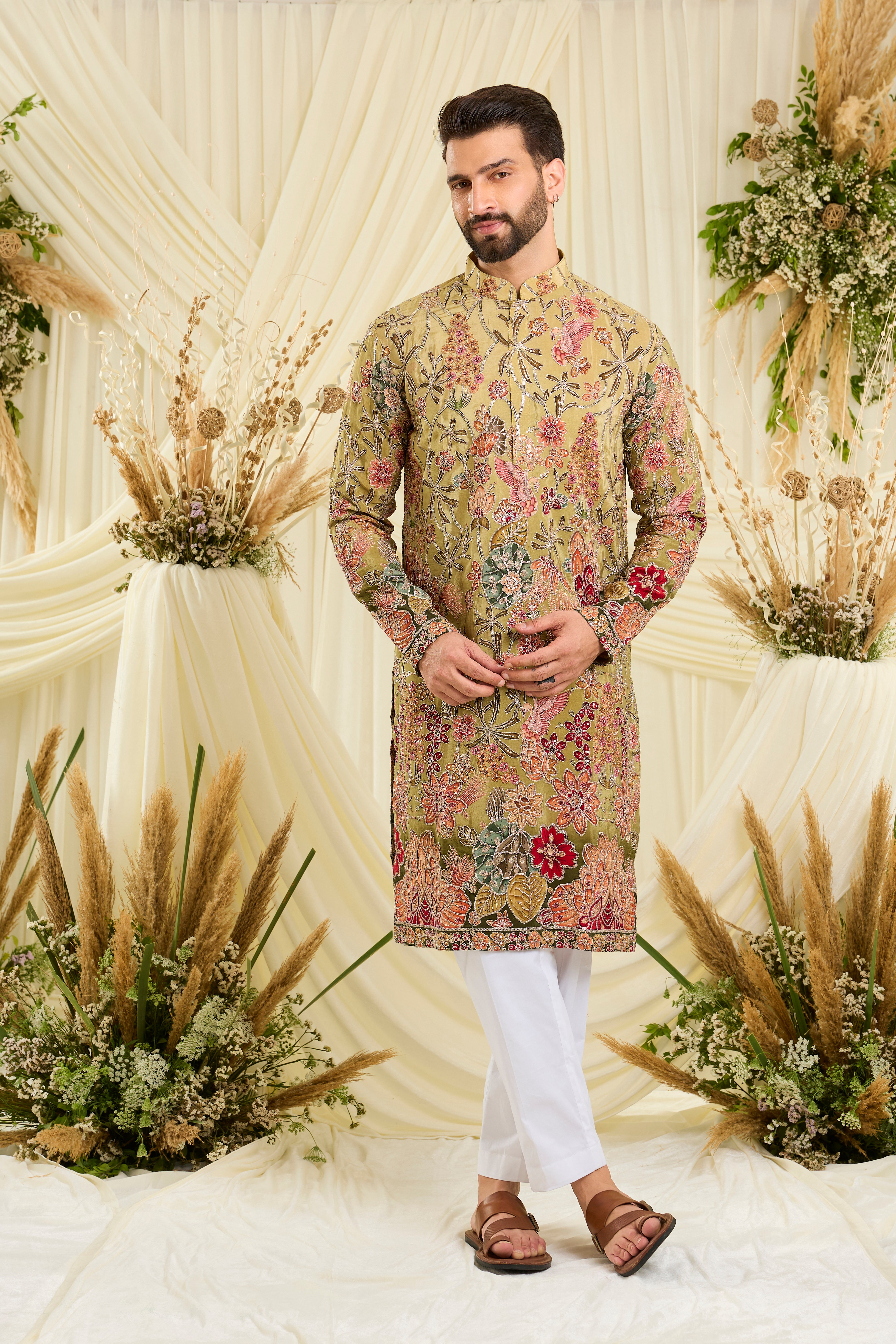 Pastel green kurta with intricate floral embroidery, rich zari detailing, and delicate sequins for a refined, luminous festive statement.