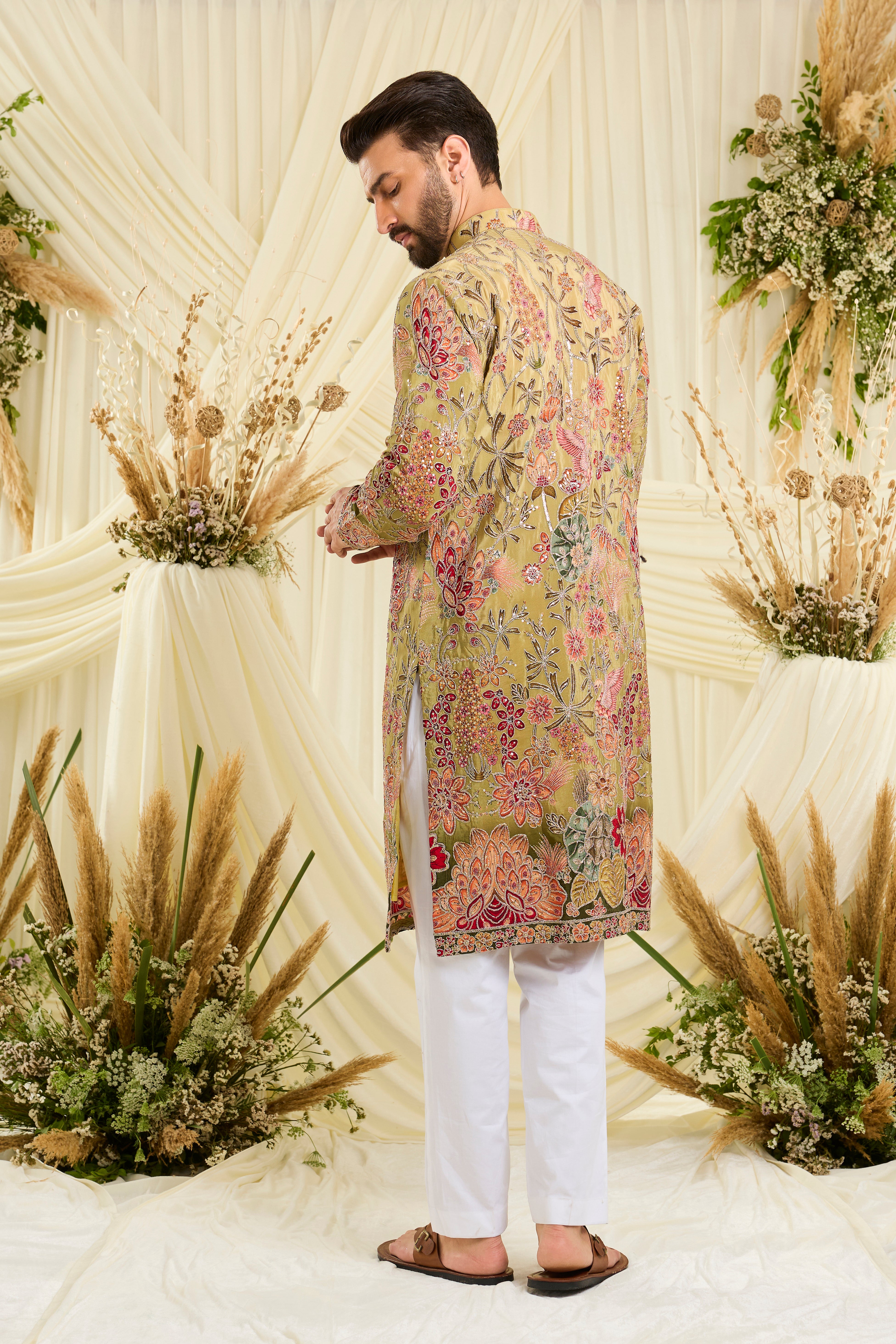 Pastel green kurta with intricate floral embroidery, rich zari detailing, and delicate sequins for a refined, luminous festive statement.