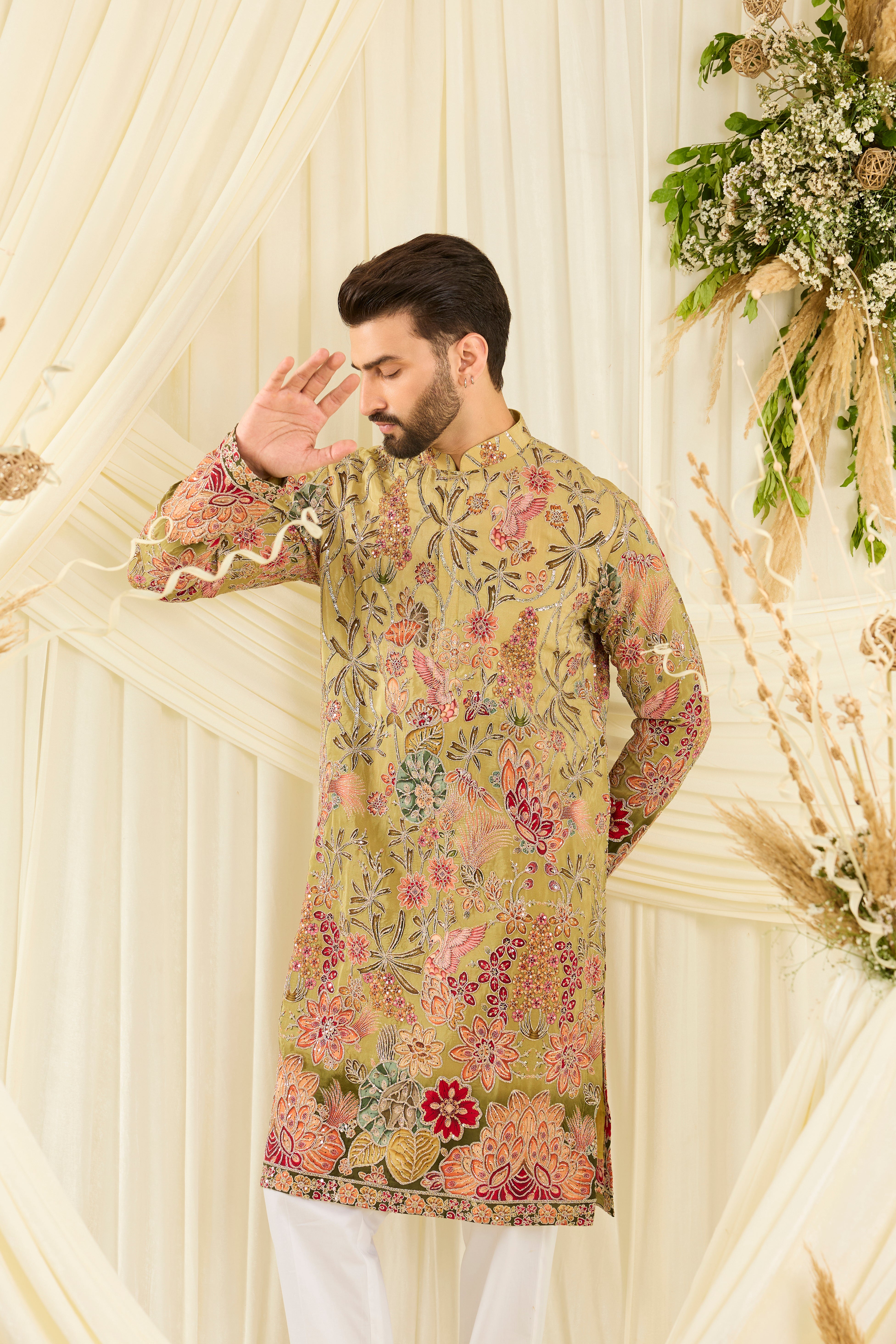 Pastel green kurta with intricate floral embroidery, rich zari detailing, and delicate sequins for a refined, luminous festive statement.