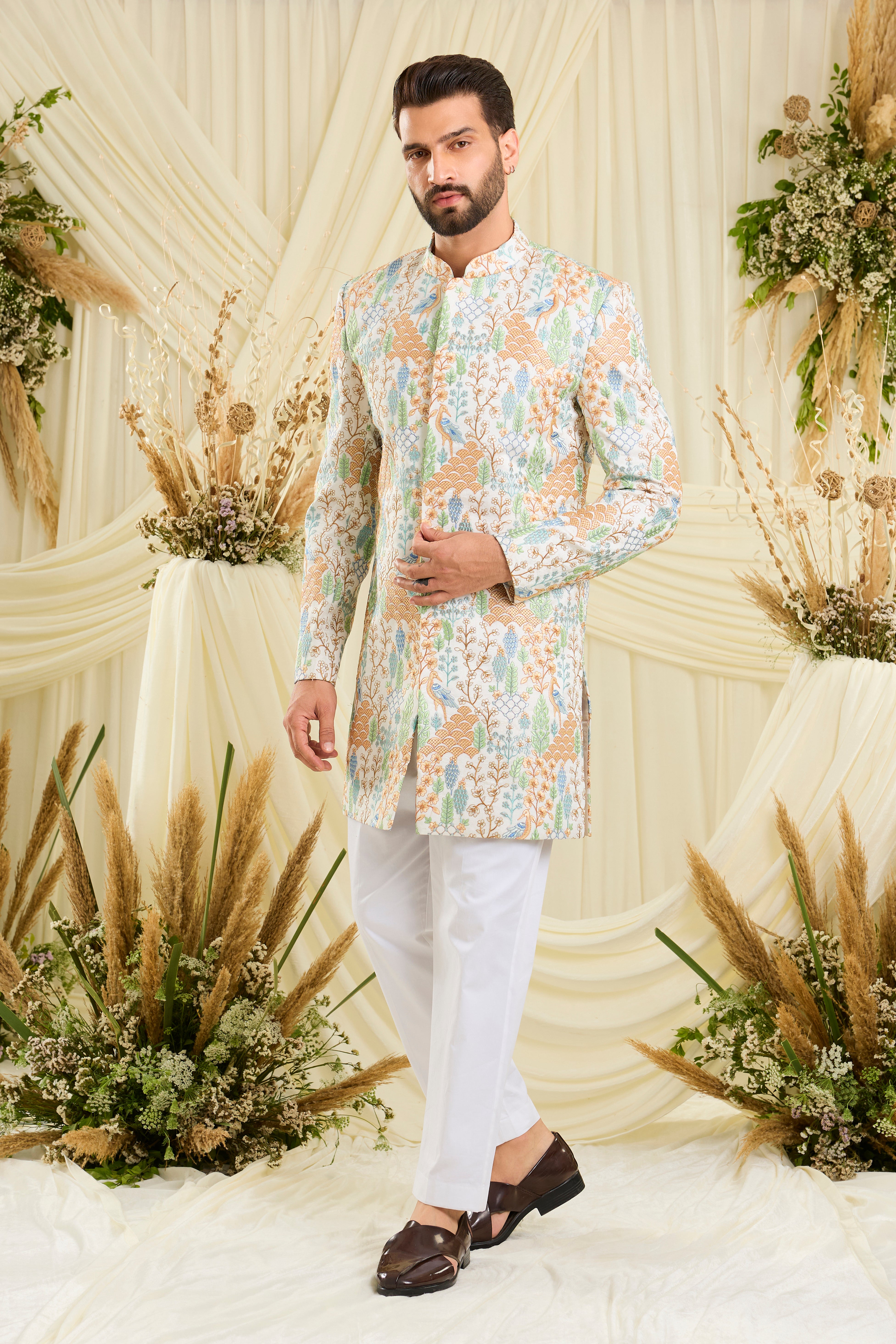 Ivory short sherwani with heavy flora-fauna embroidery, multicolour threadwork, and delicate sequins for a richly detailed, luxe statement.