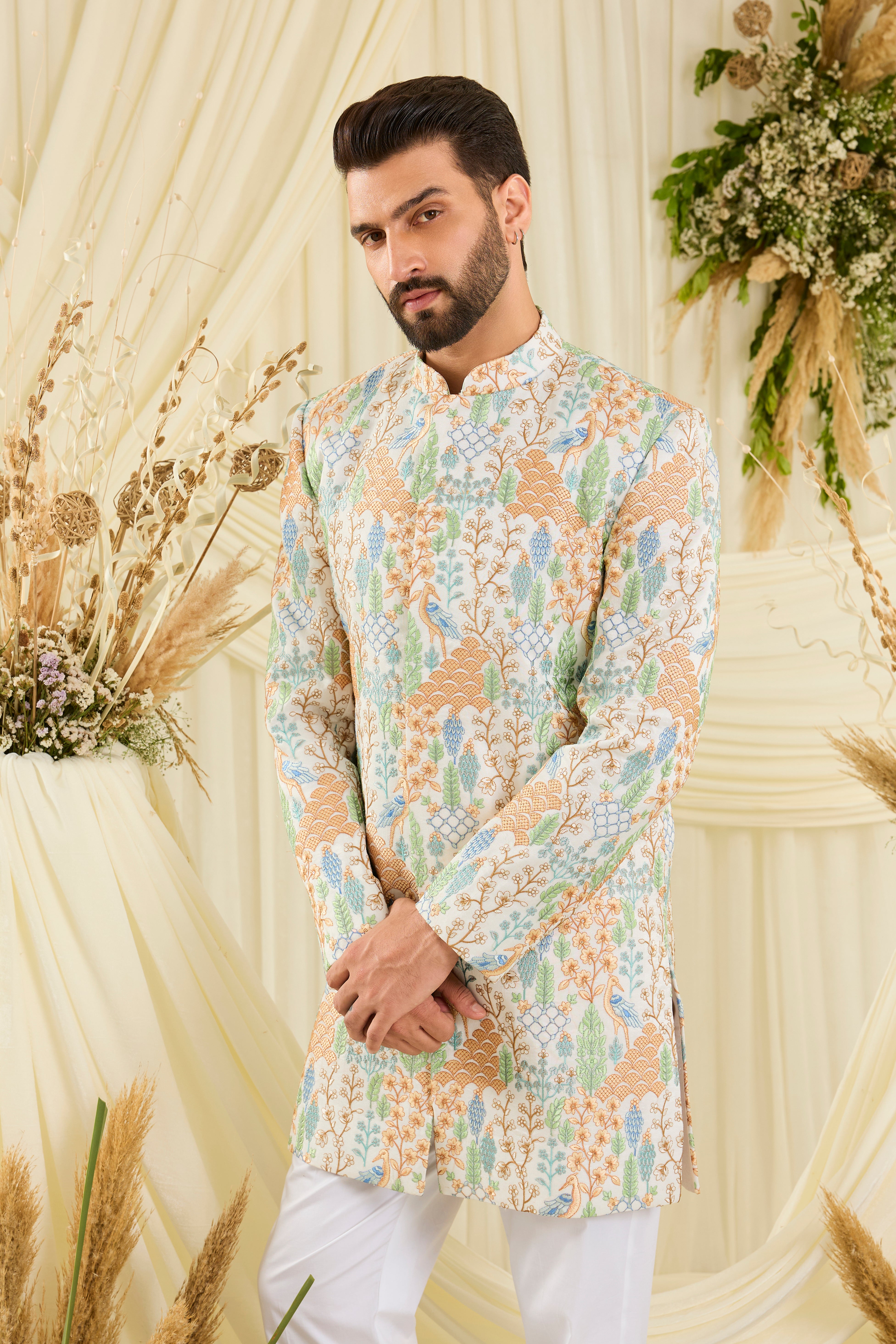 Ivory short sherwani with heavy flora-fauna embroidery, multicolour threadwork, and delicate sequins for a richly detailed, luxe statement.