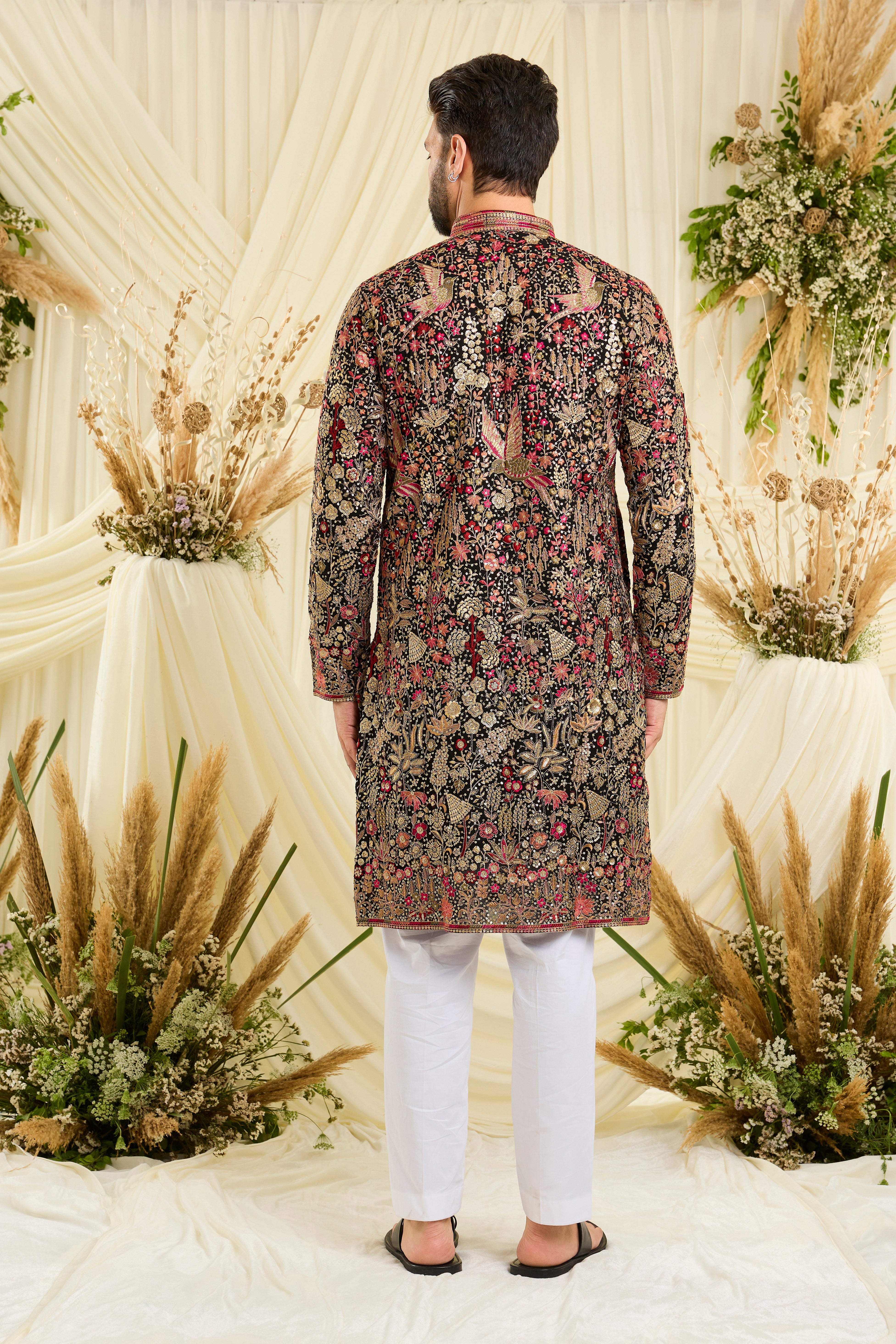 Black sequined kurta with intricate flora-fauna embroidery, multicolour threadwork, sequins, and a delicately detailed neckline for elevated festive elegance
