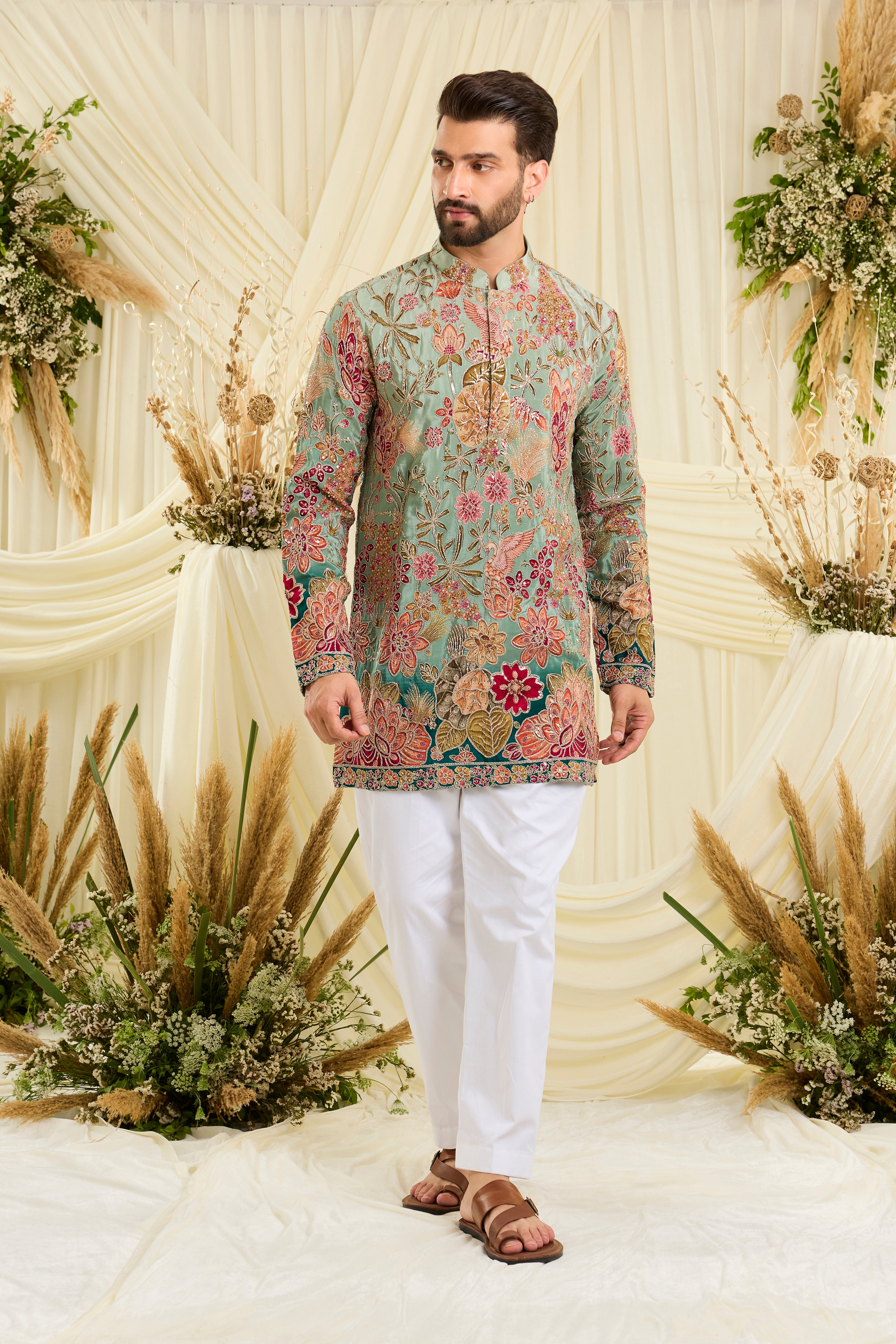 Pastel blue/aqua short kurta with intricate floral embroidery, rich zari detailing, and delicate sequins for a refined, luminous festive statement.