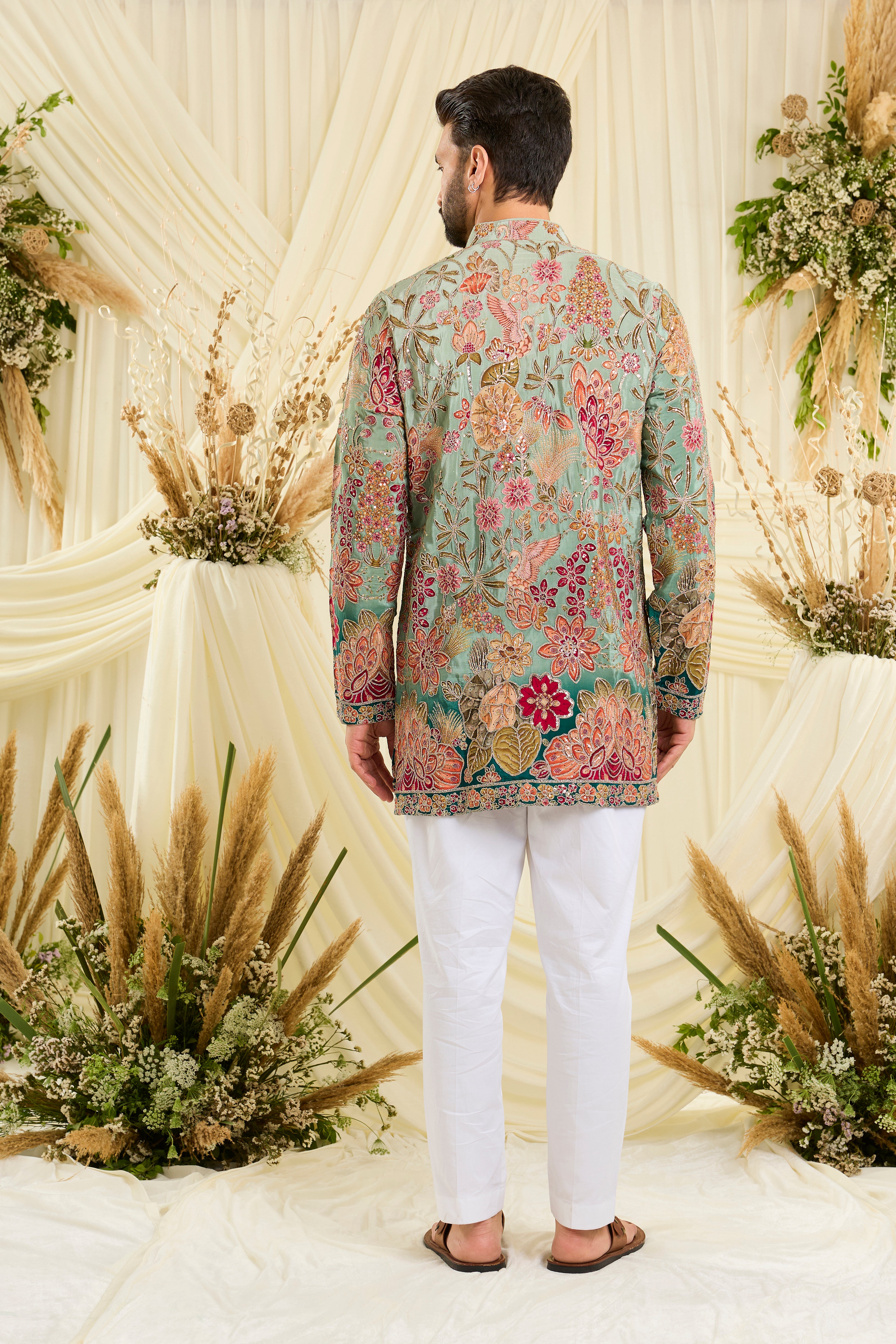 Pastel blue/aqua short kurta with intricate floral embroidery, rich zari detailing, and delicate sequins for a refined, luminous festive statement.