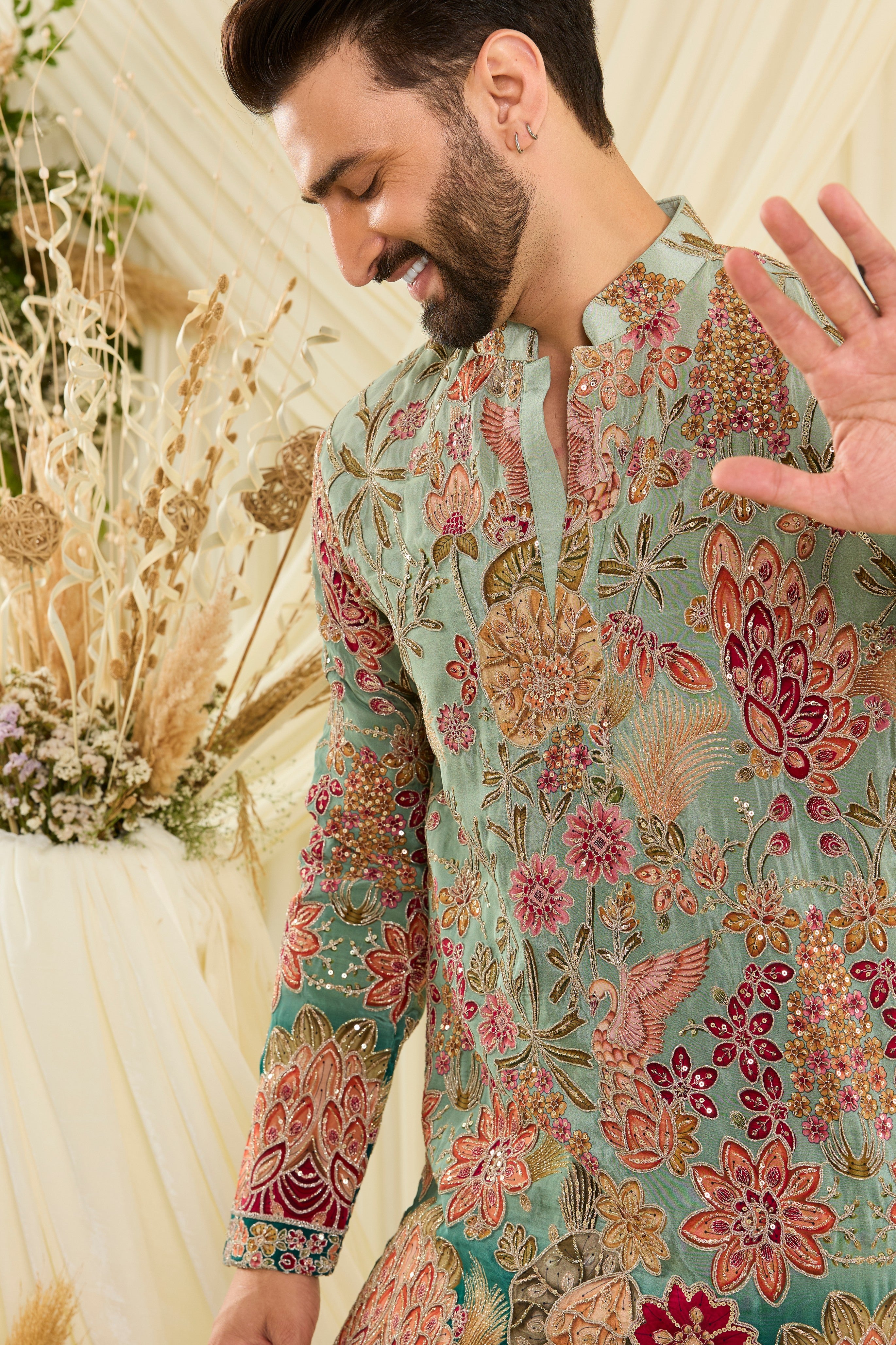 Pastel blue/aqua short kurta with intricate floral embroidery, rich zari detailing, and delicate sequins for a refined, luminous festive statement.