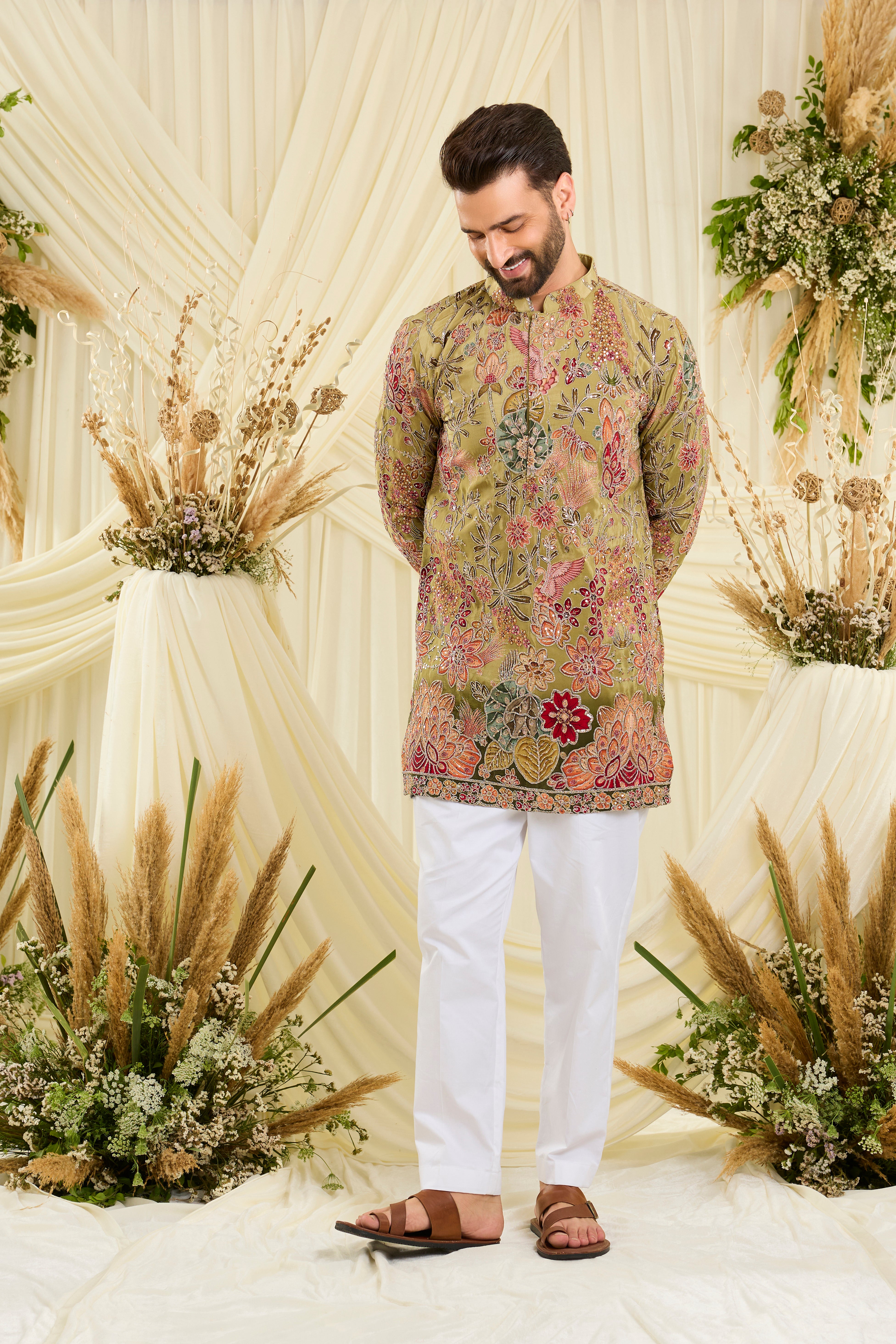 Pastel green kurta with intricate floral embroidery, rich zari detailing, and delicate sequins for a refined, luminous festive statement.