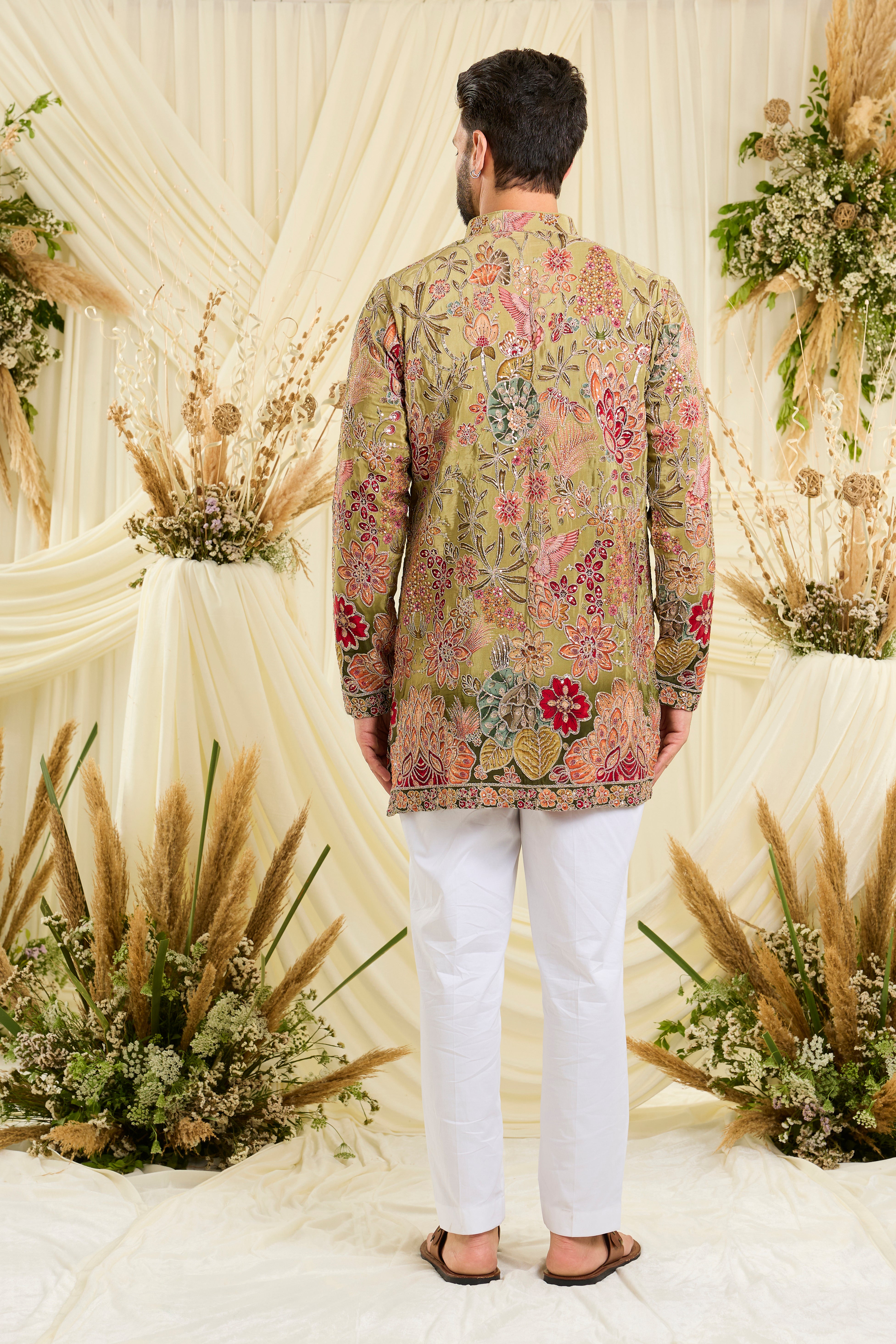 Pastel green kurta with intricate floral embroidery, rich zari detailing, and delicate sequins for a refined, luminous festive statement.
