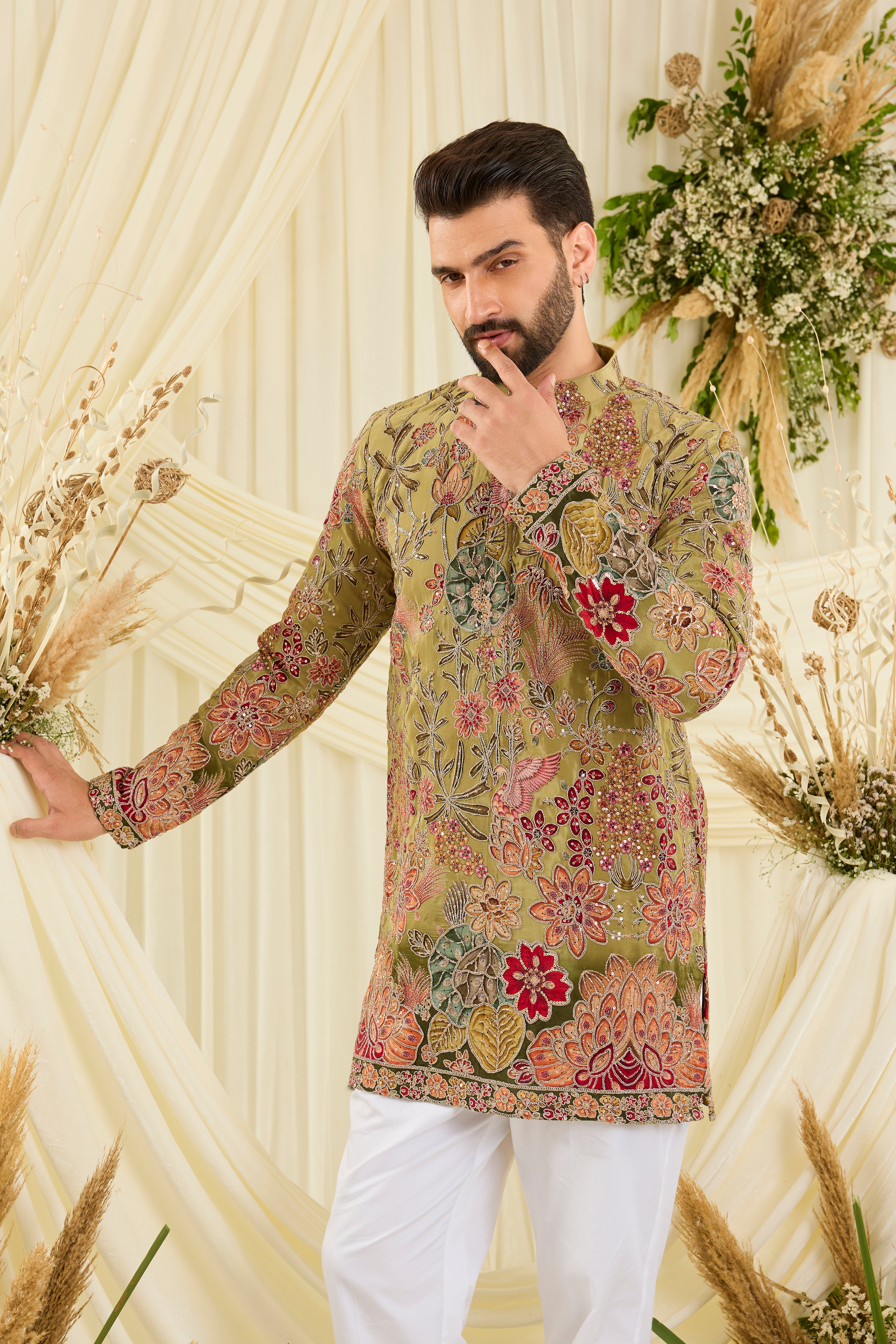 Pastel green kurta with intricate floral embroidery, rich zari detailing, and delicate sequins for a refined, luminous festive statement.