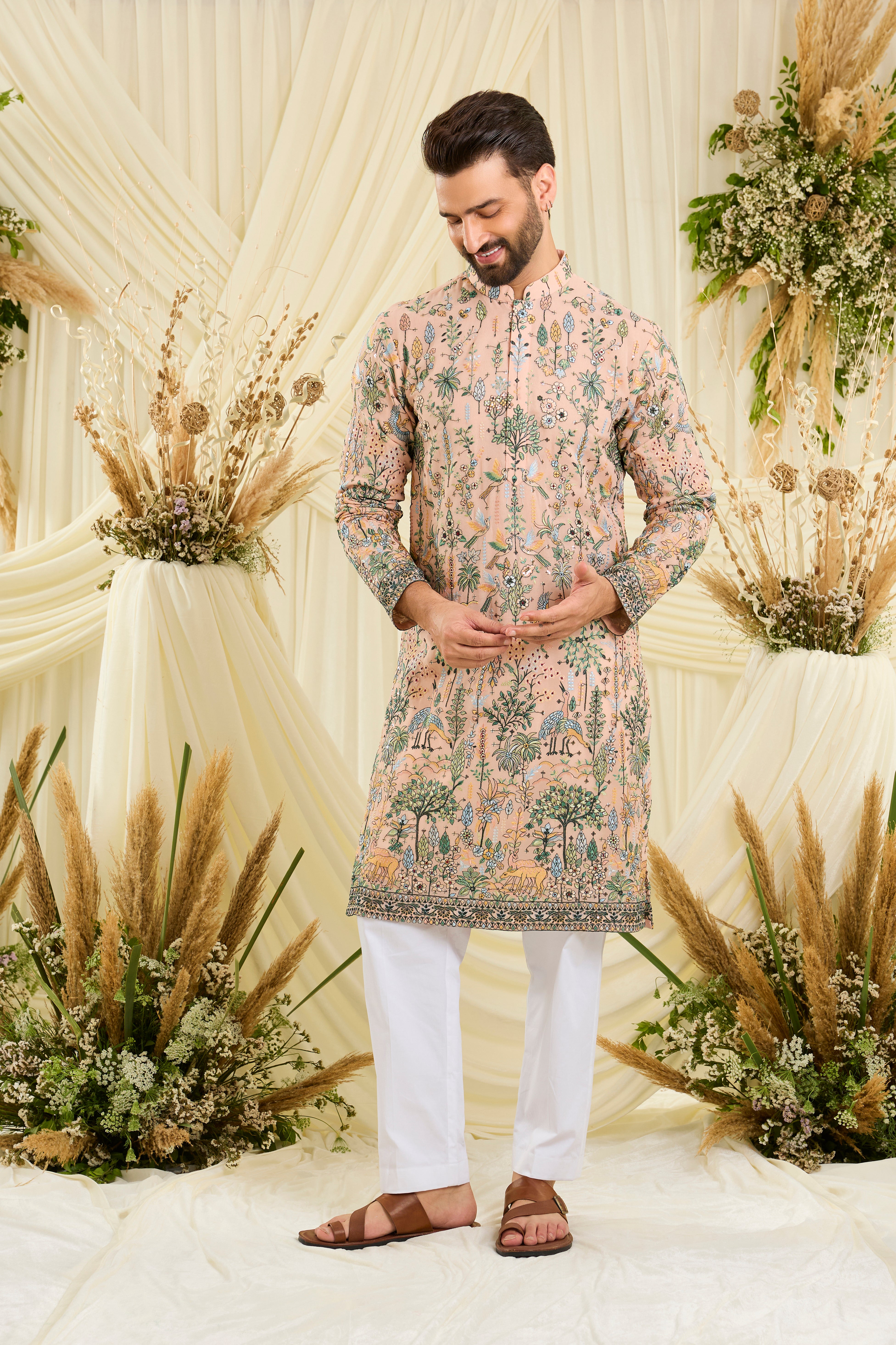 Light peach kurta with intricate flora-fauna embroidery, multicolour threadwork, and delicate sequins for a fresh, elevated festive look.