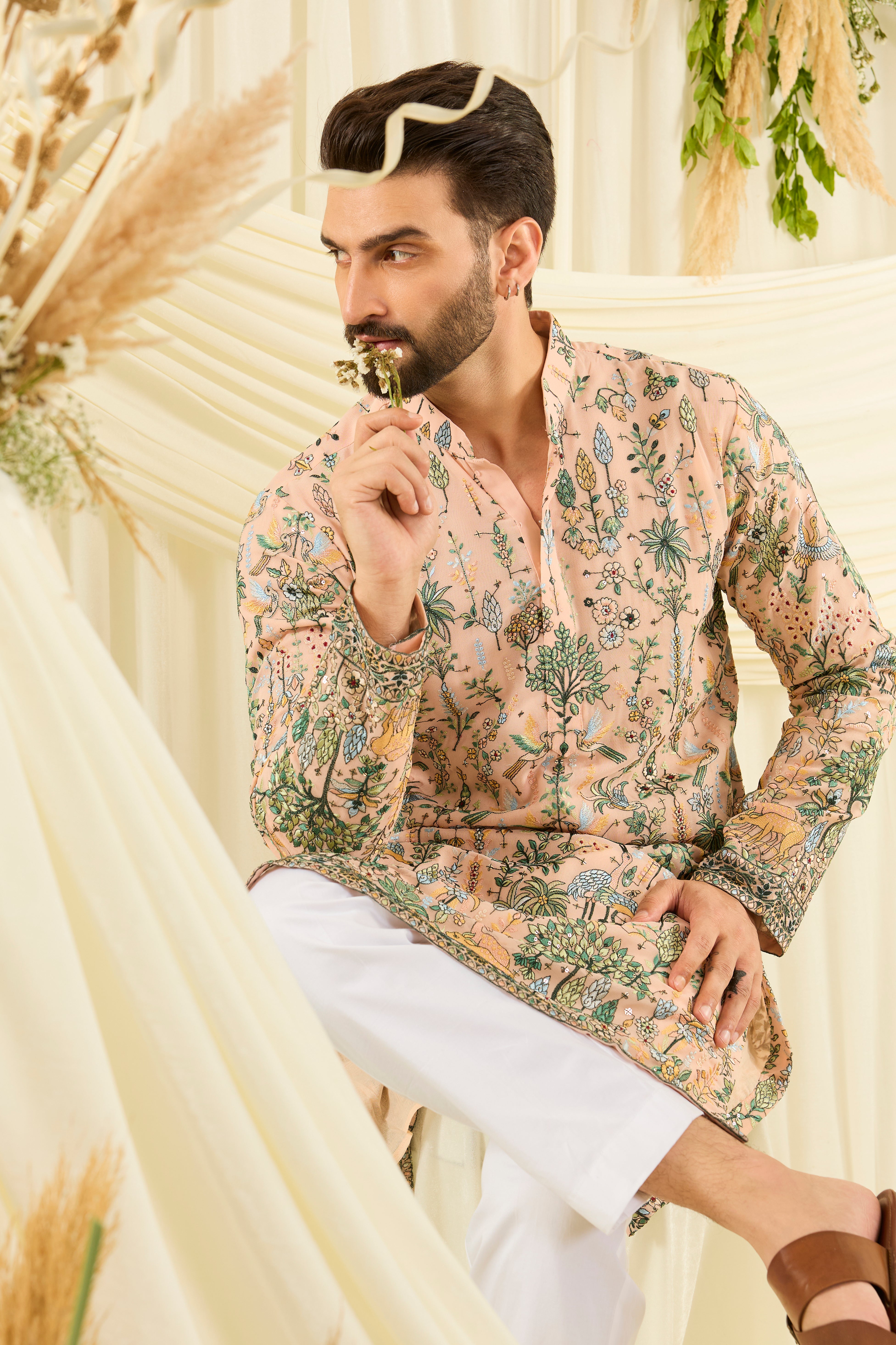Light peach kurta with intricate flora-fauna embroidery, multicolour threadwork, and delicate sequins for a fresh, elevated festive look.