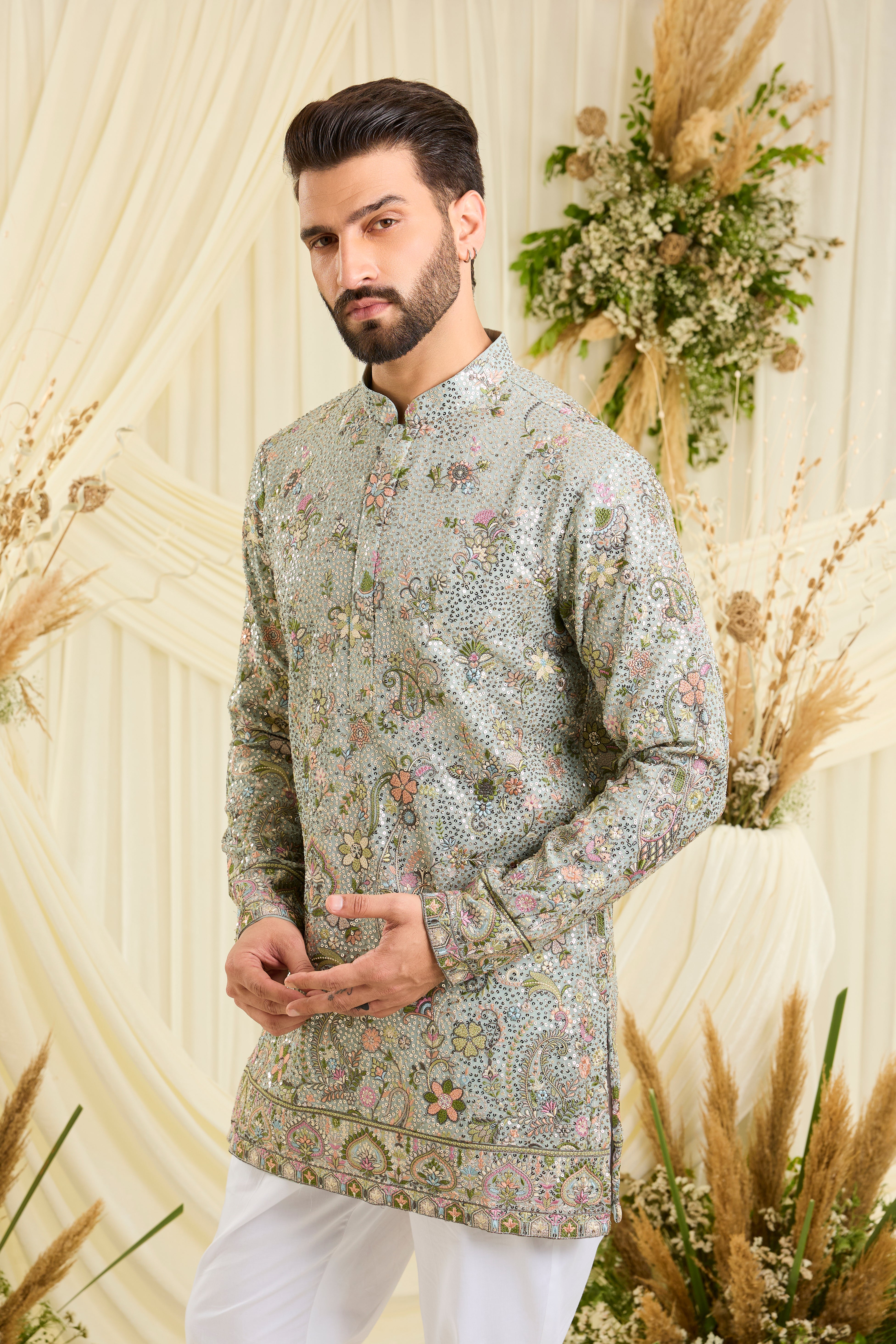 Blue sequined short kurta with intricate floral embroidery, multicolour threadwork, and delicate sequins for a fresh, elevated festive look.
