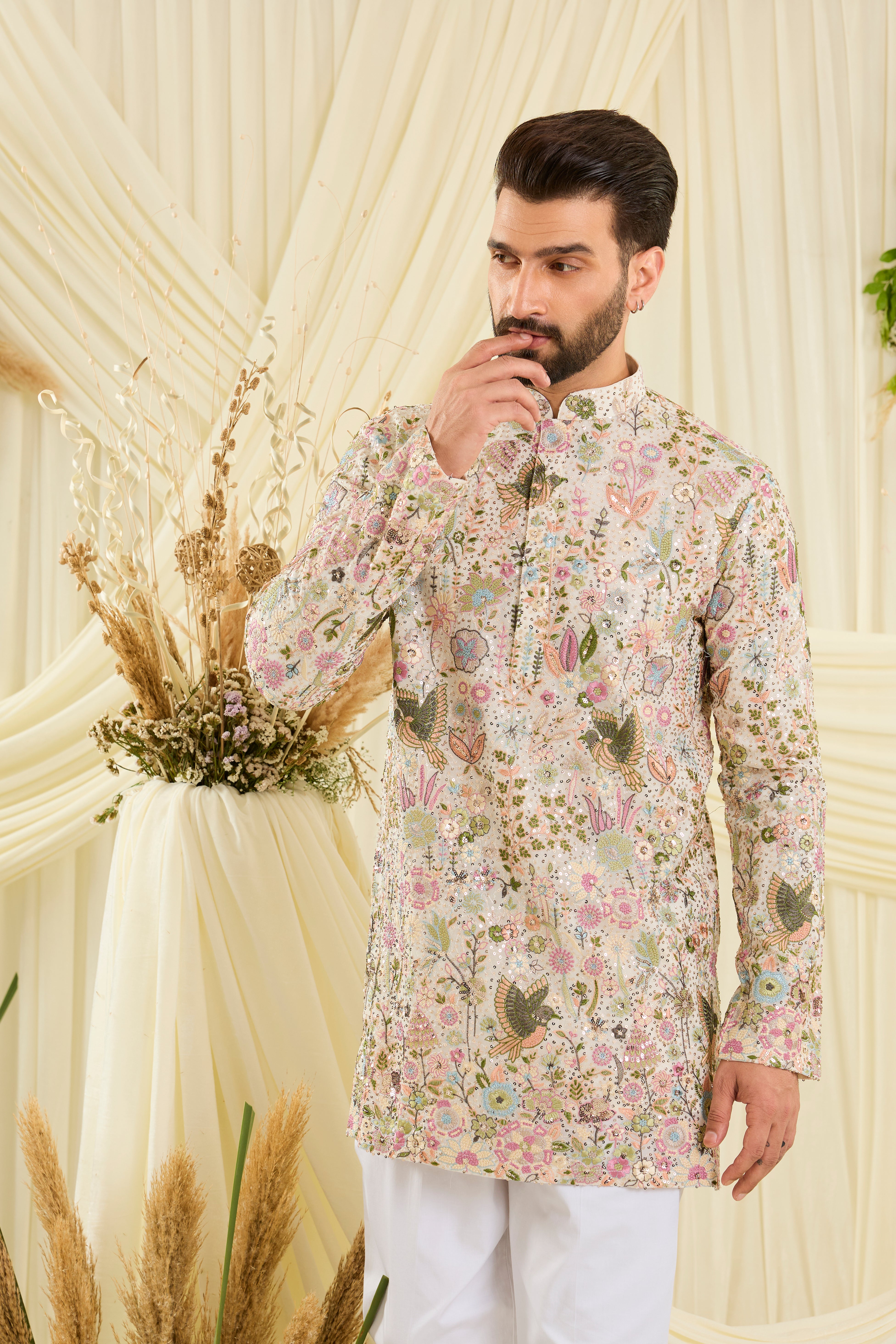 Ivory sequined short kurta with intricate flora-fauna embroidery, multicolour threadwork, and detailed sequins for a fresh, elevated festive look.