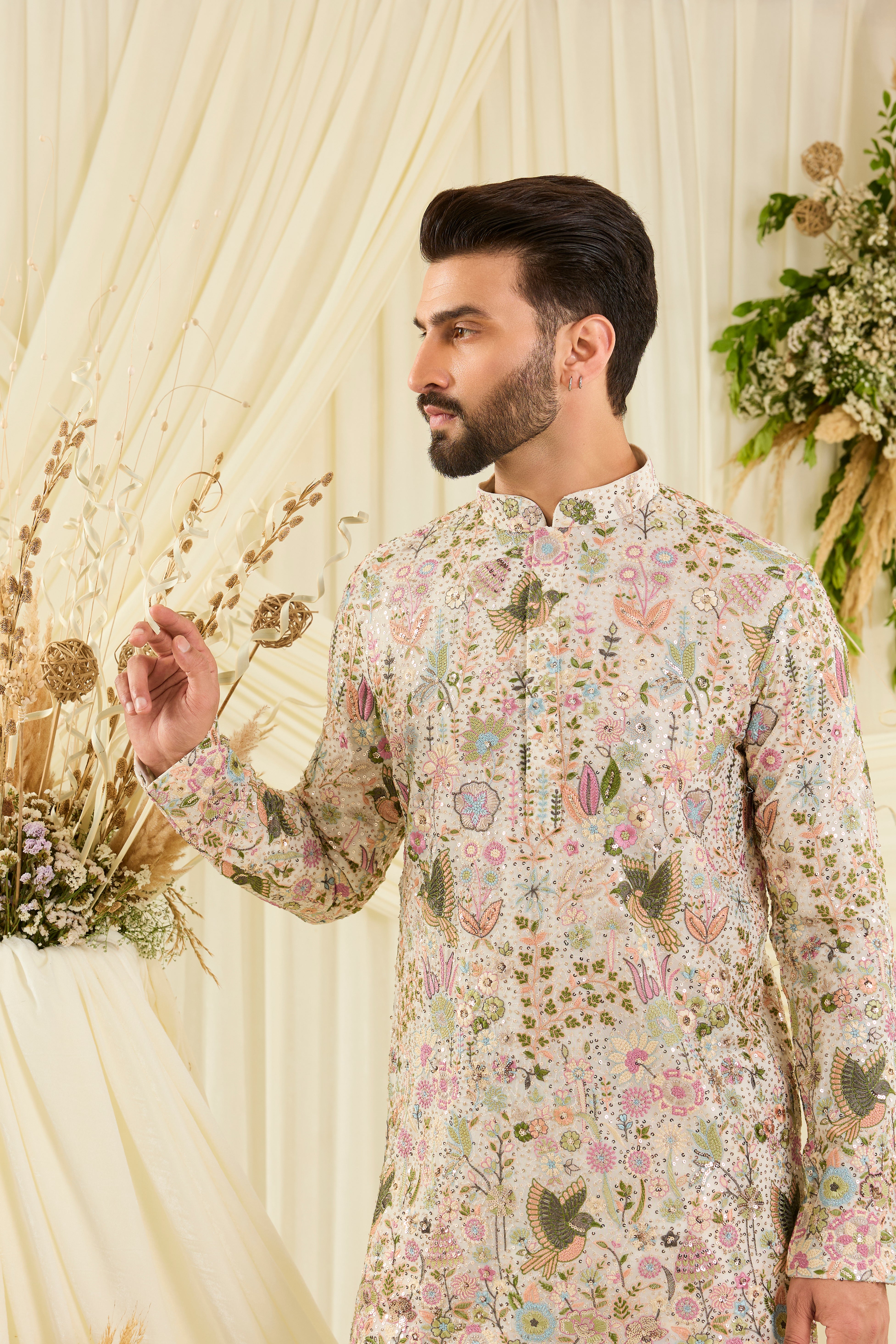 Ivory sequined short kurta with intricate flora-fauna embroidery, multicolour threadwork, and detailed sequins for a fresh, elevated festive look.
