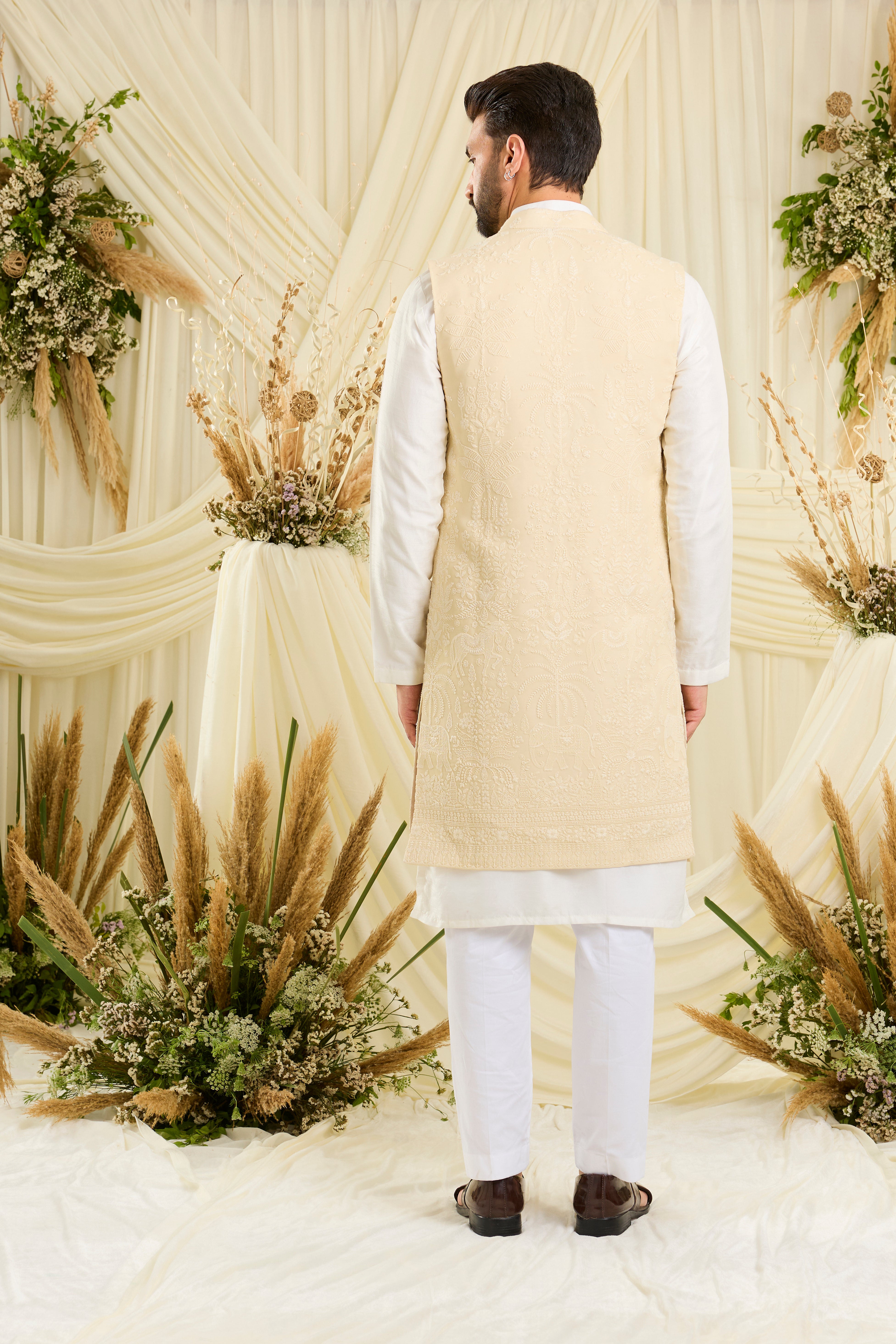 Yellow chikankari long jacket with ivory threadwork, flora-fauna embroidery, and delicate sequins for a refined, luminous couture statement.