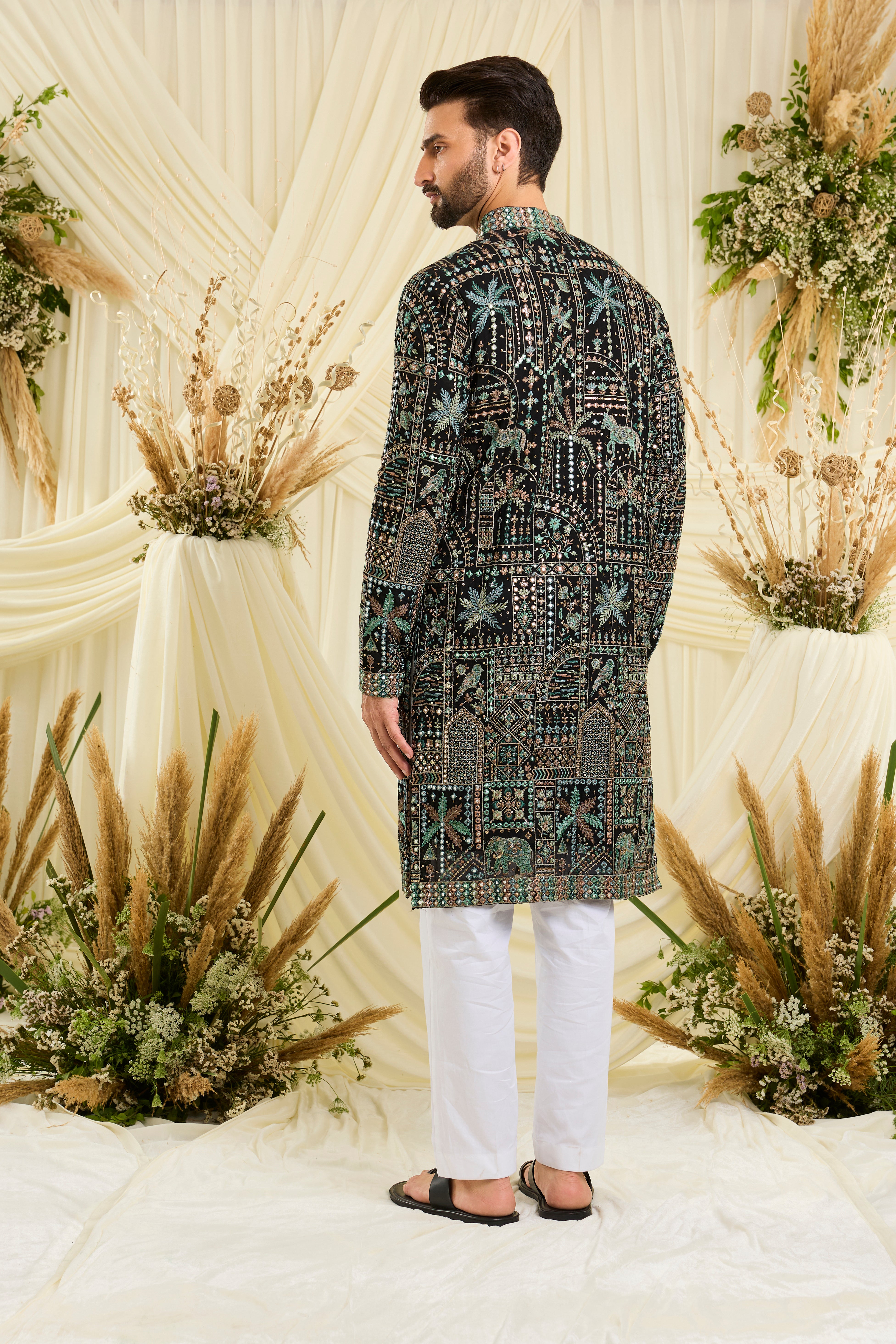 Black kurta with flora-fauna embroidery, multicolour threadwork, and mirror-like sequins — bold, luminous, and effortlessly luxurious.