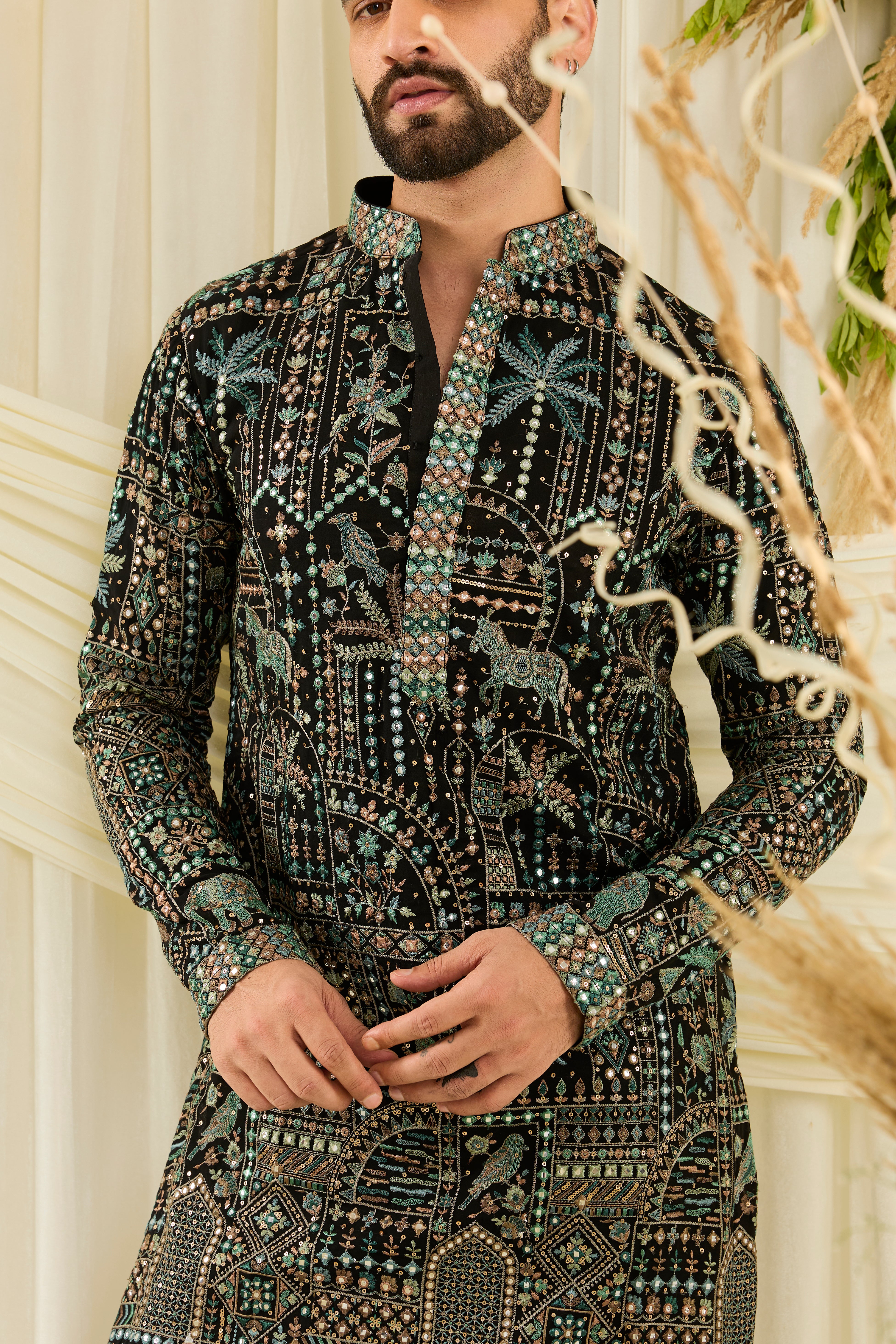 Black kurta with flora-fauna embroidery, multicolour threadwork, and mirror-like sequins — bold, luminous, and effortlessly luxurious.