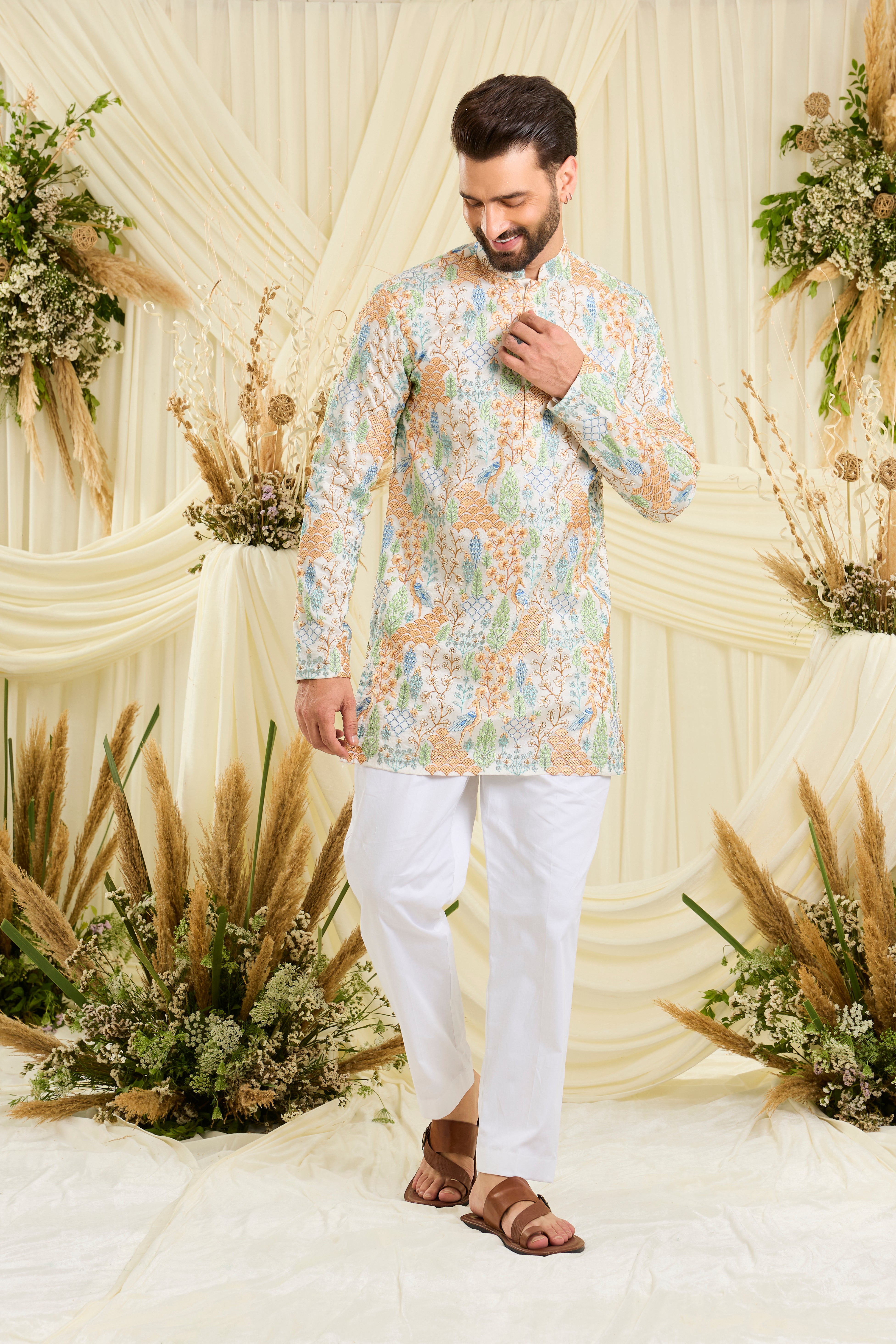 Ivory short kurta with heavy flora-fauna embroidery, multicolour threadwork, and delicate sequins for a richly detailed, luxe statement.